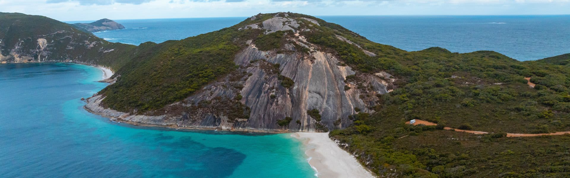 Aerial view of Misery Beach and Bald Head walking trail surrounded by water