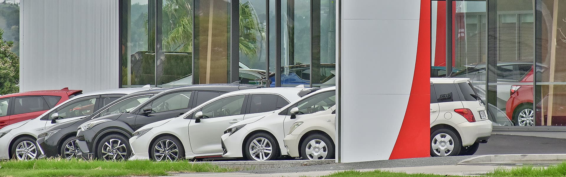 A row of cars for sale outside a car dealership