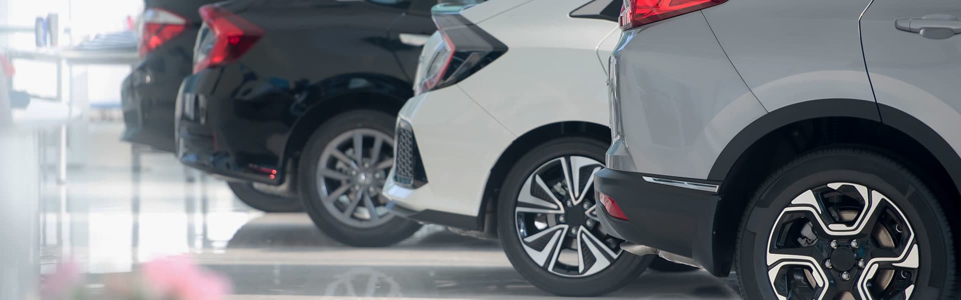Four showroom cars lined up