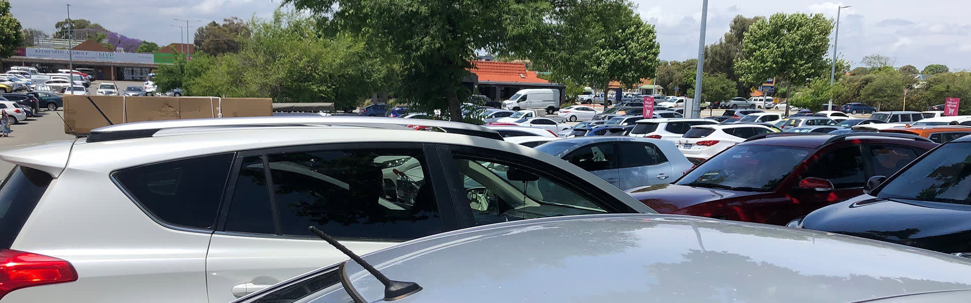 A view over a busy shopping centre car park