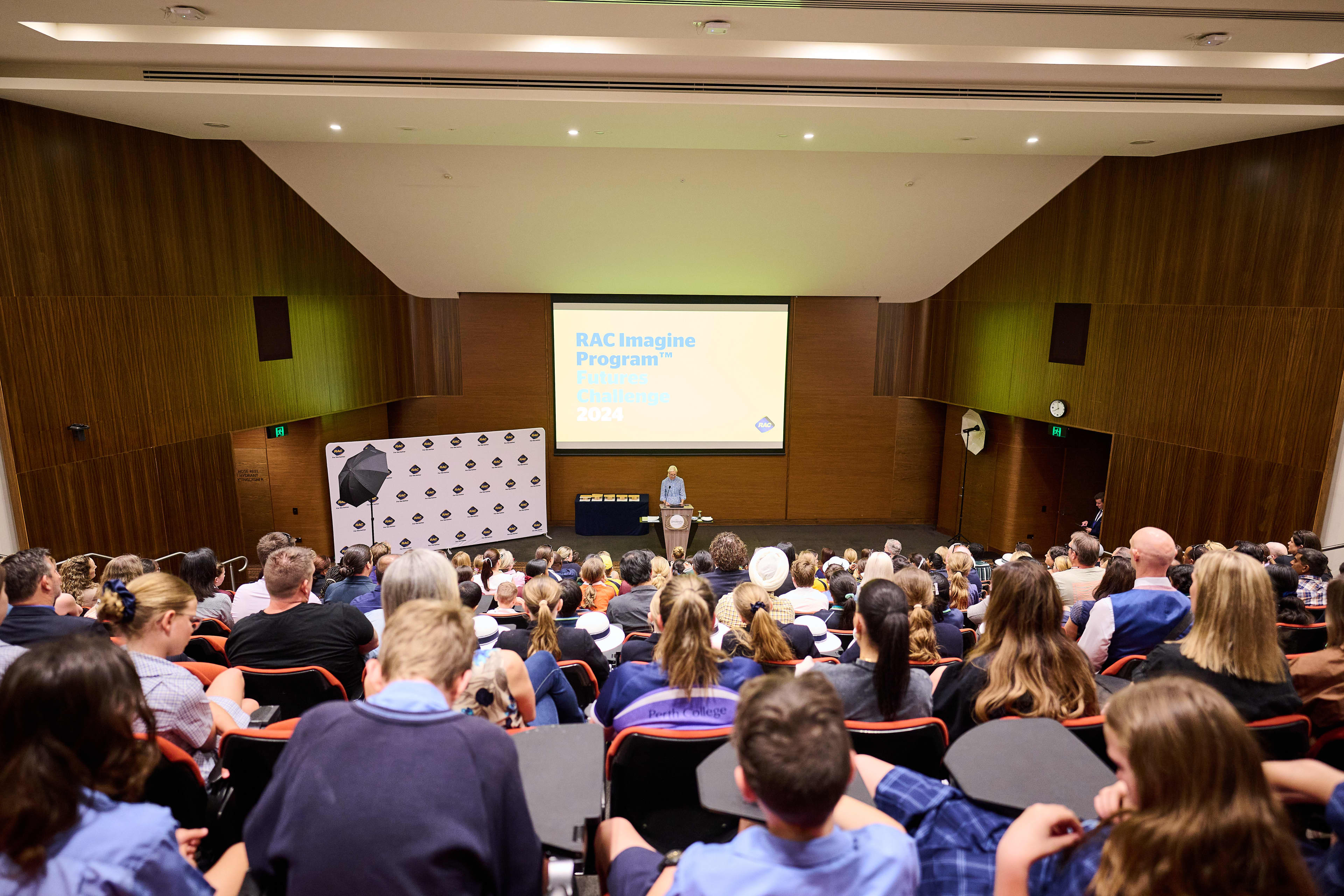 Auditorium full of school kids attending a seminar.