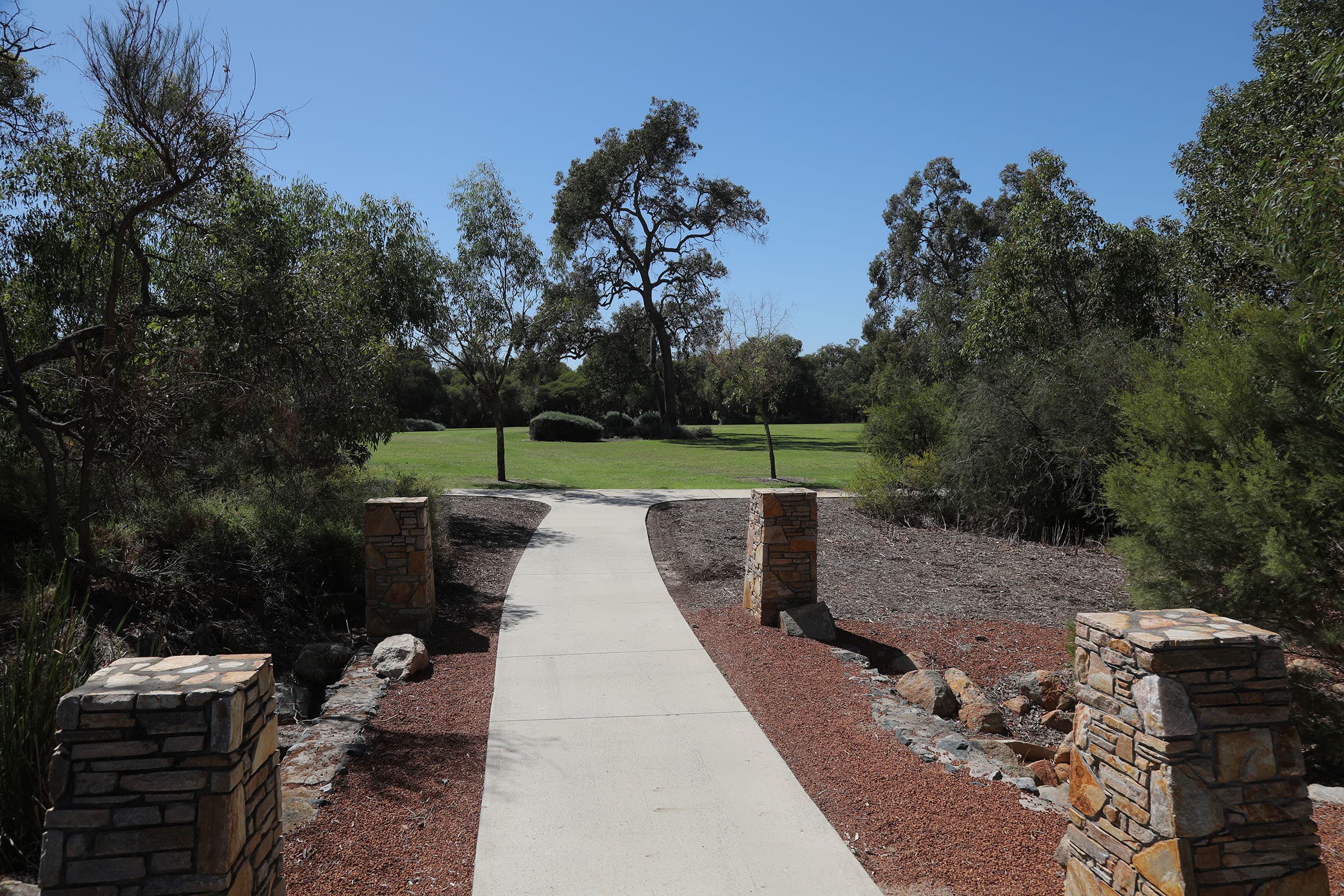 Pathway to a park with bushland either side