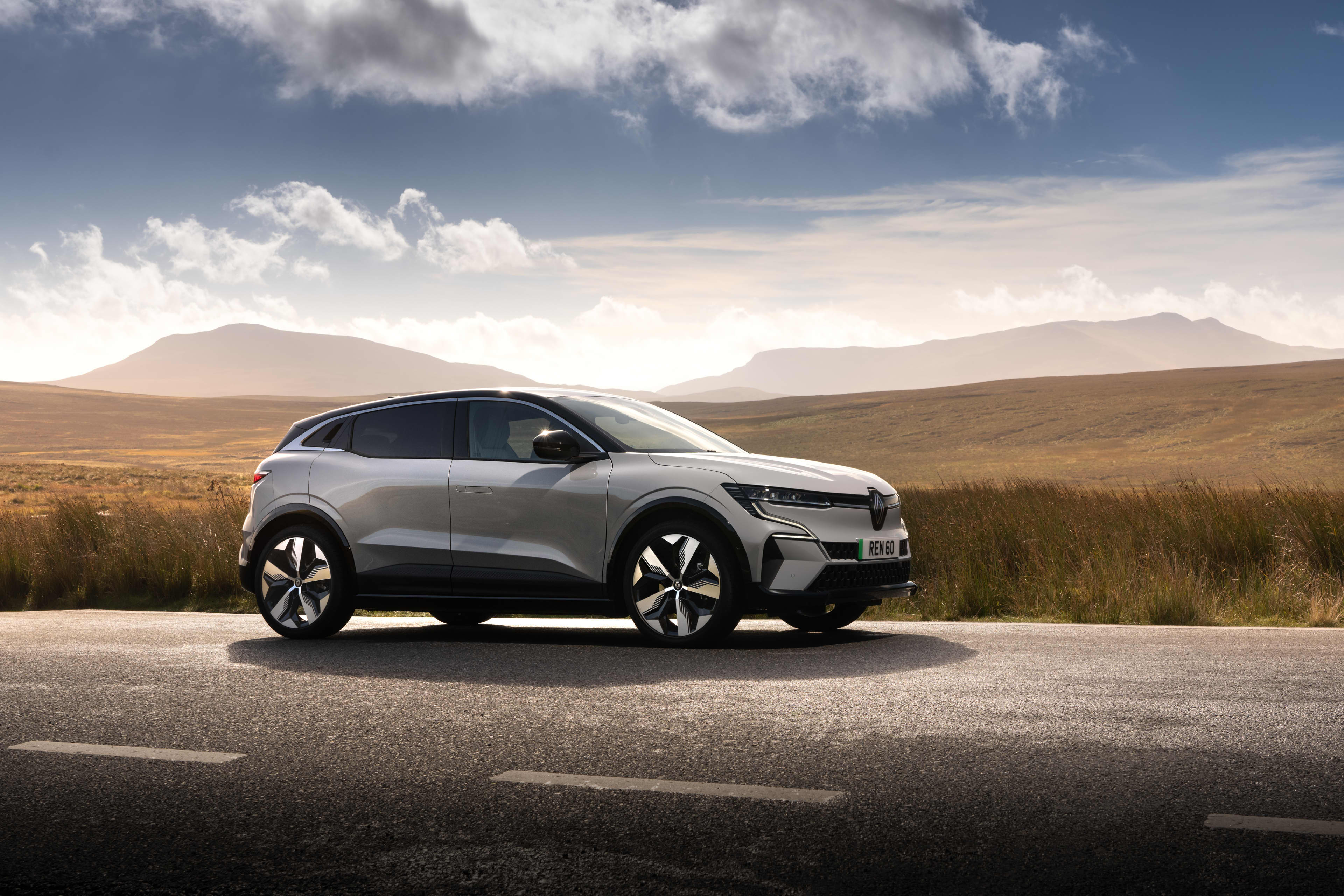 A silver Renault Megane E-Tech parked on the side of a road