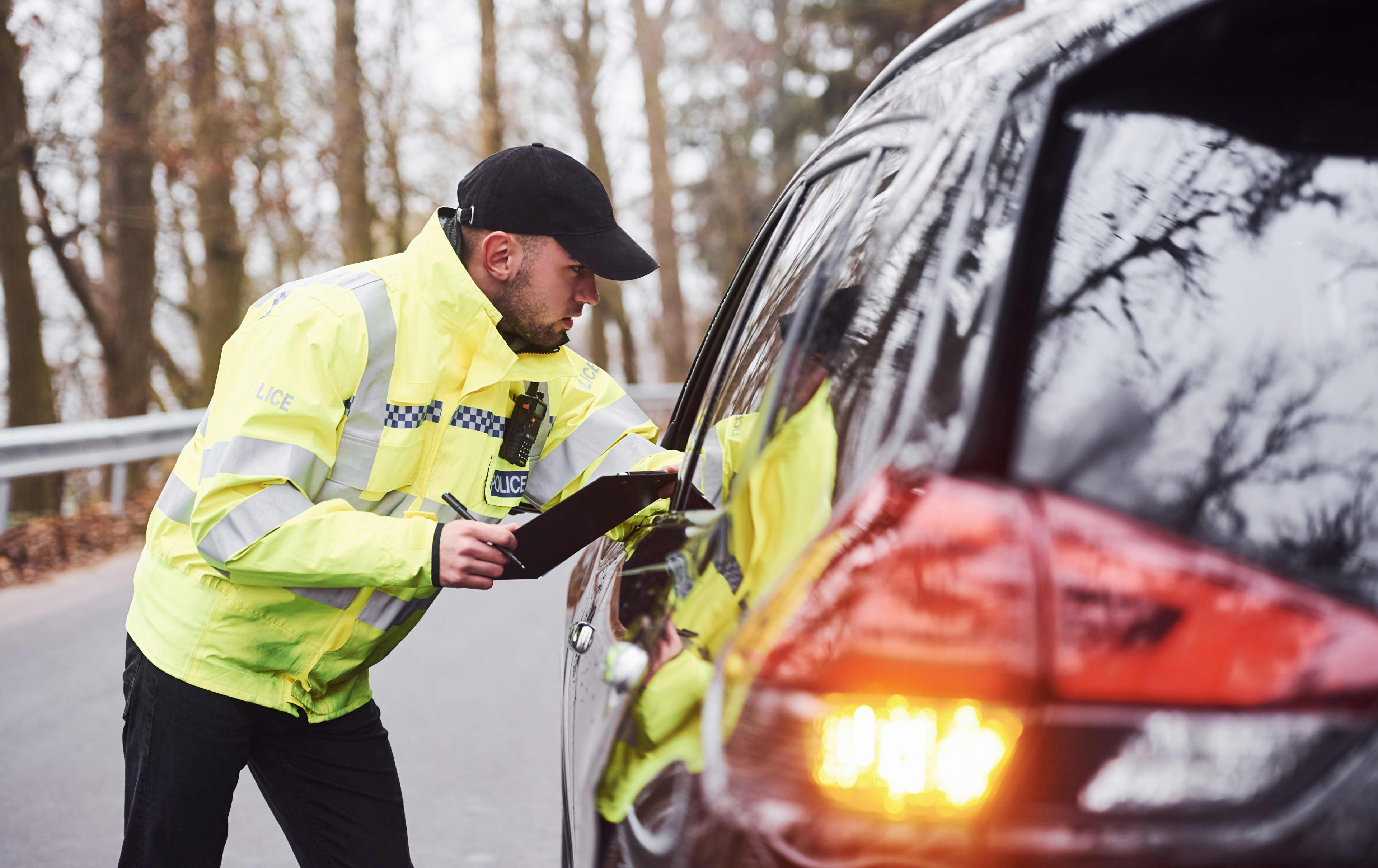 A police officer speaks to a motorist through a window