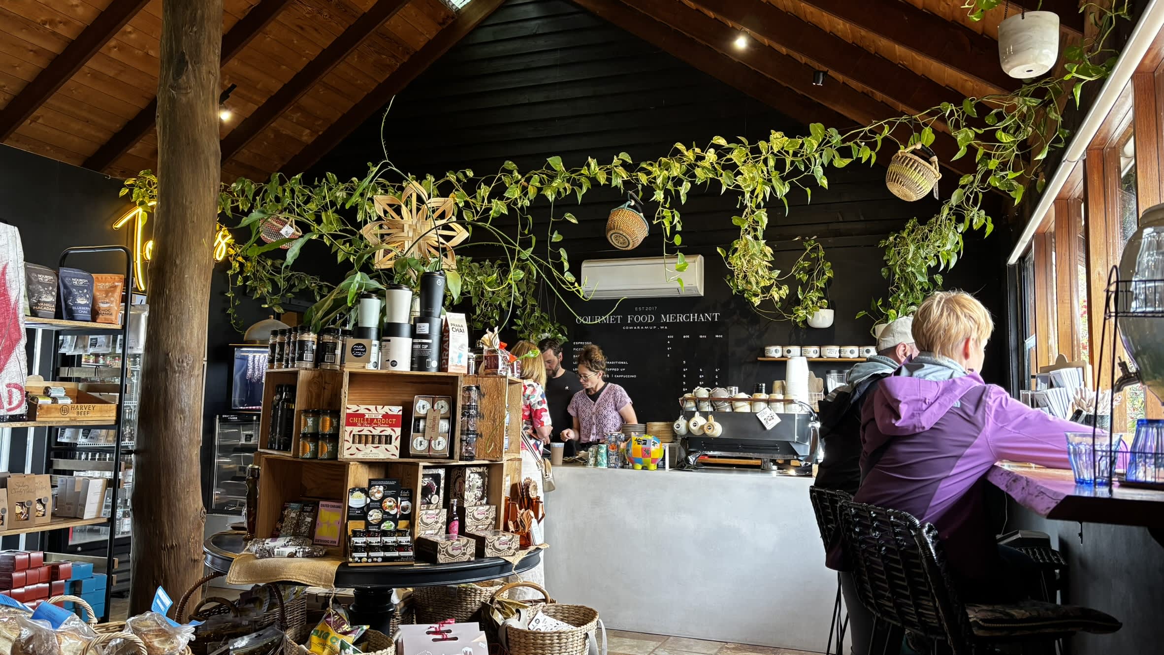 People dining and browsing inside the Gourmet Food Merchant