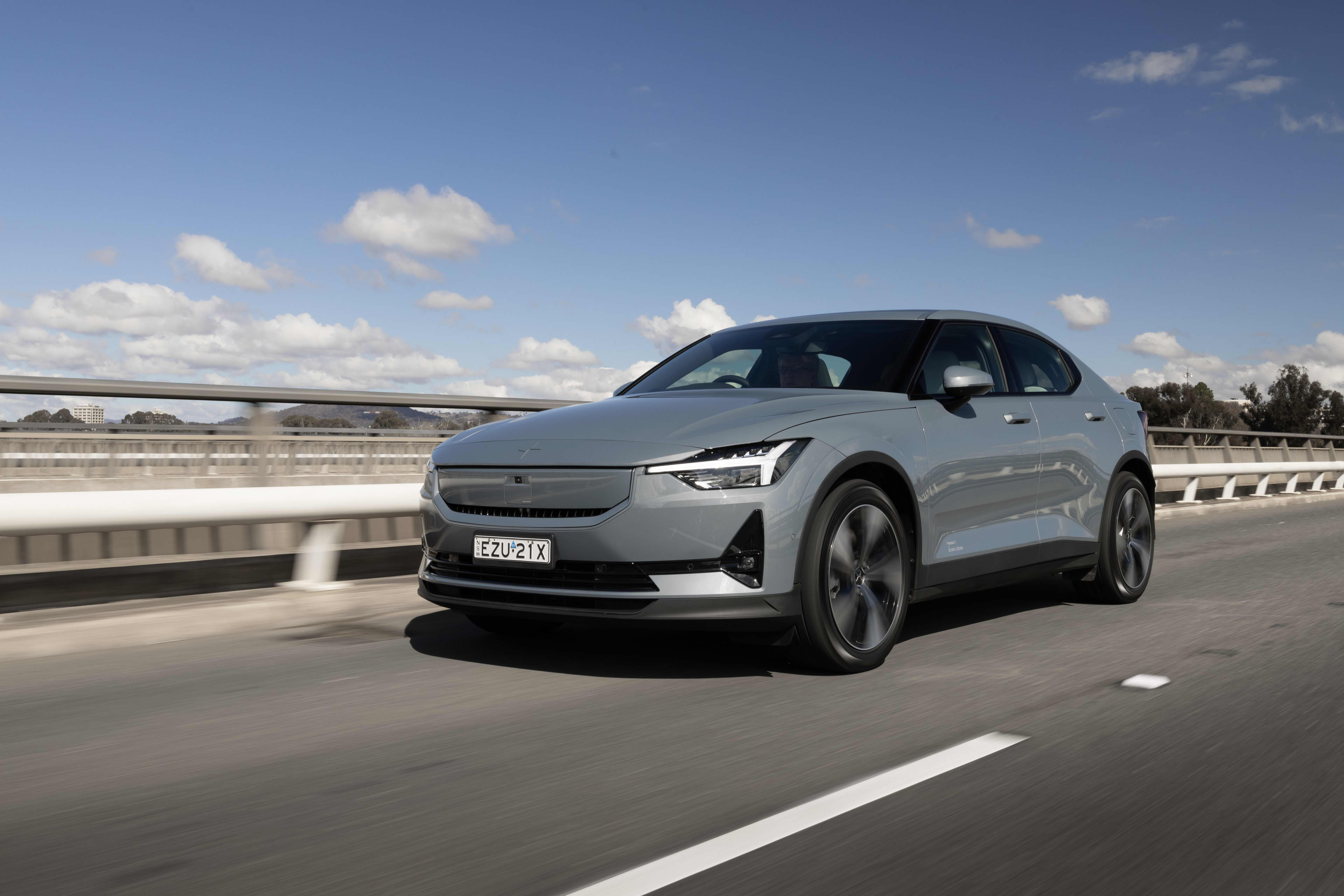 A grey Polestar EV driving across a traffic bridge