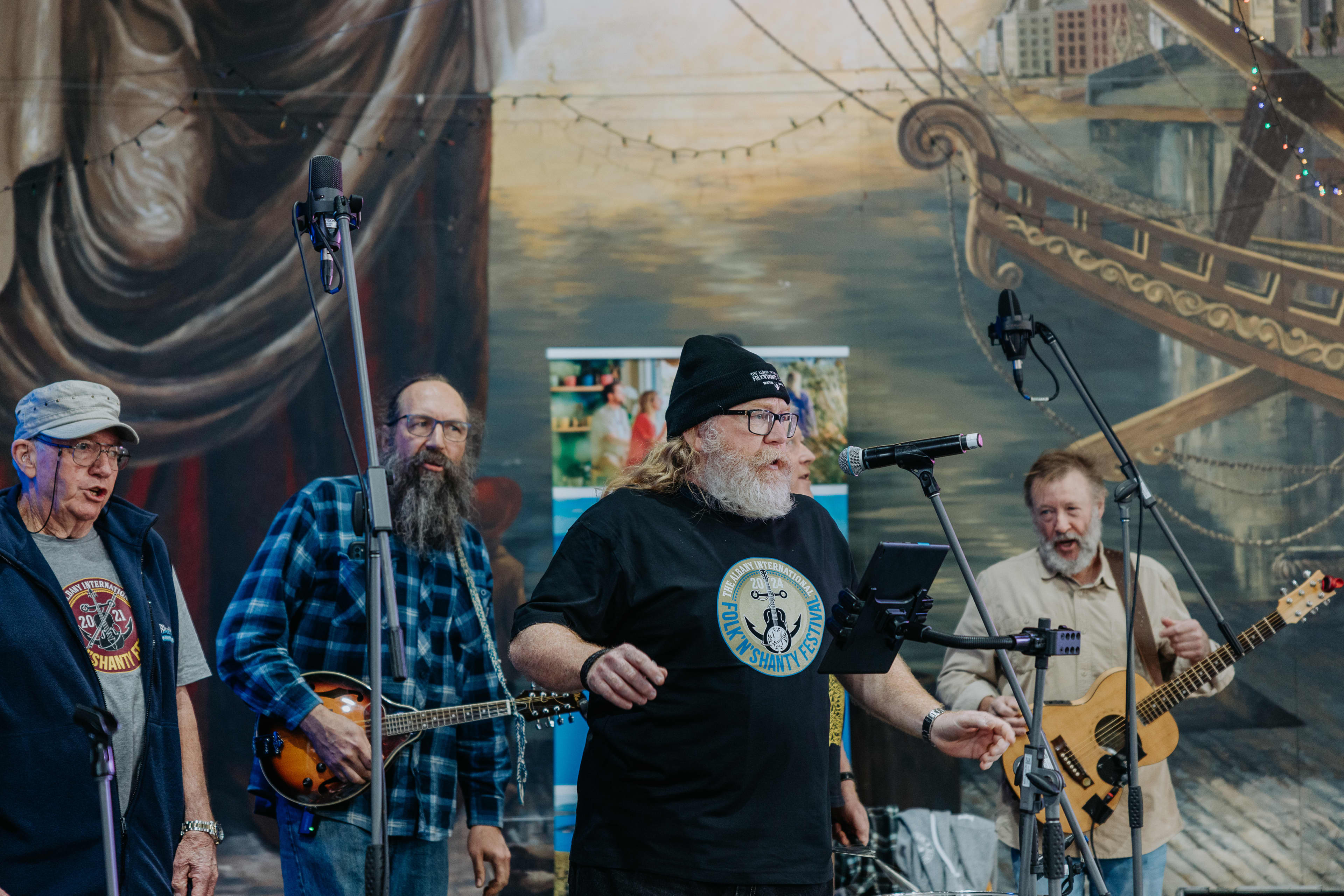 A band playing live music against a nautical-themed backdrop