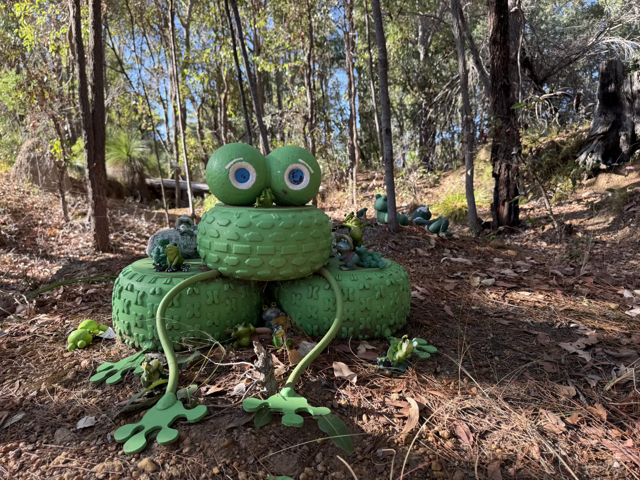 A green frog-shaped figure made of tyres