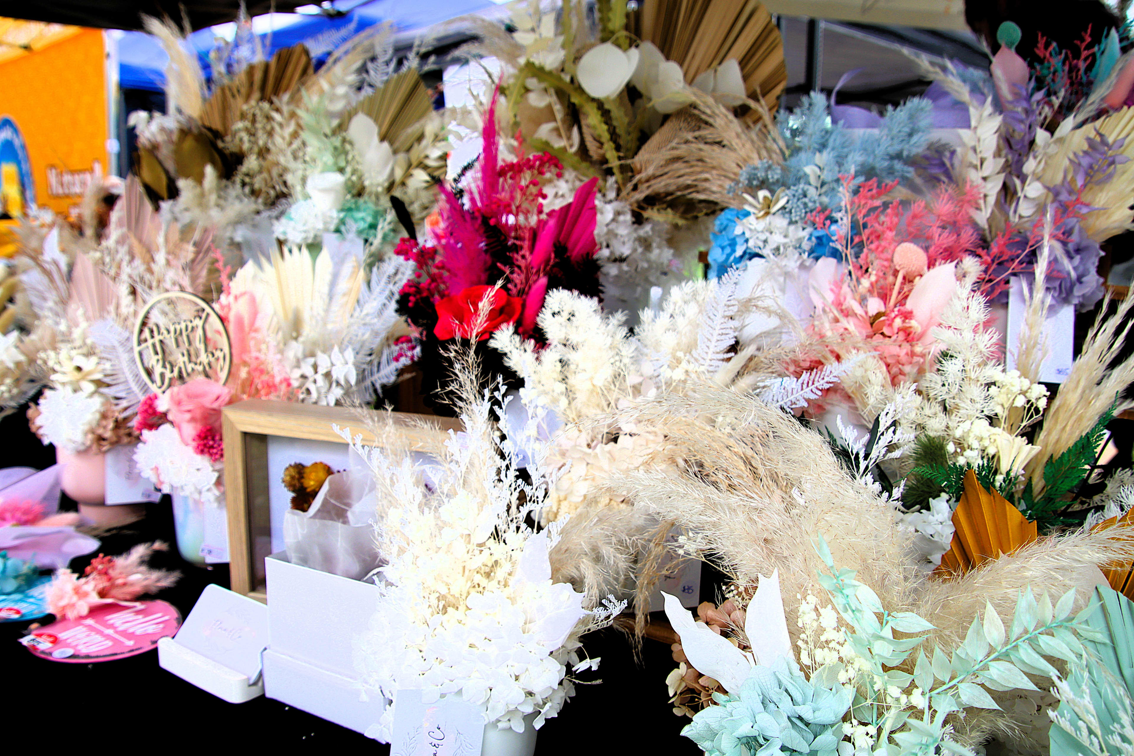 A colourful collection of flower arrangements at a market stall