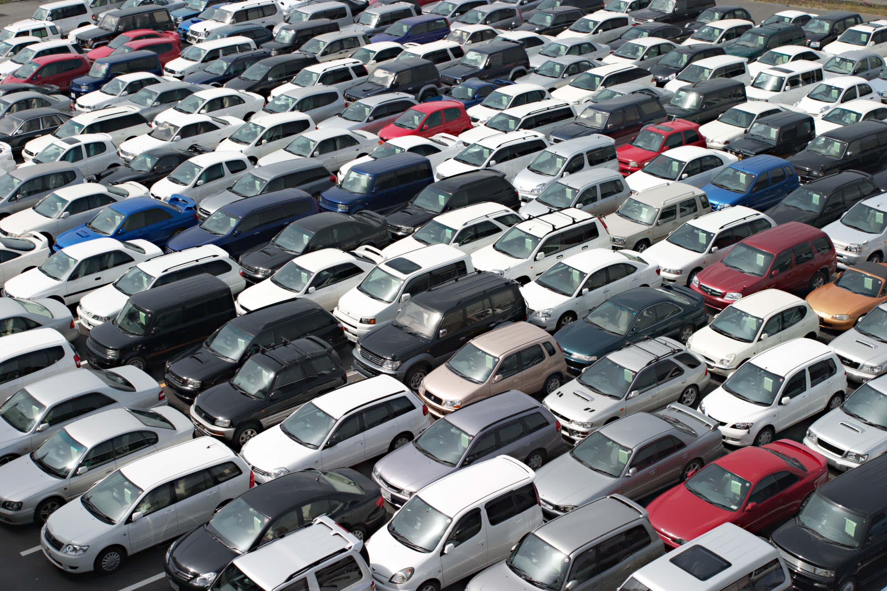 An aerial image of rows of cars in a large yard