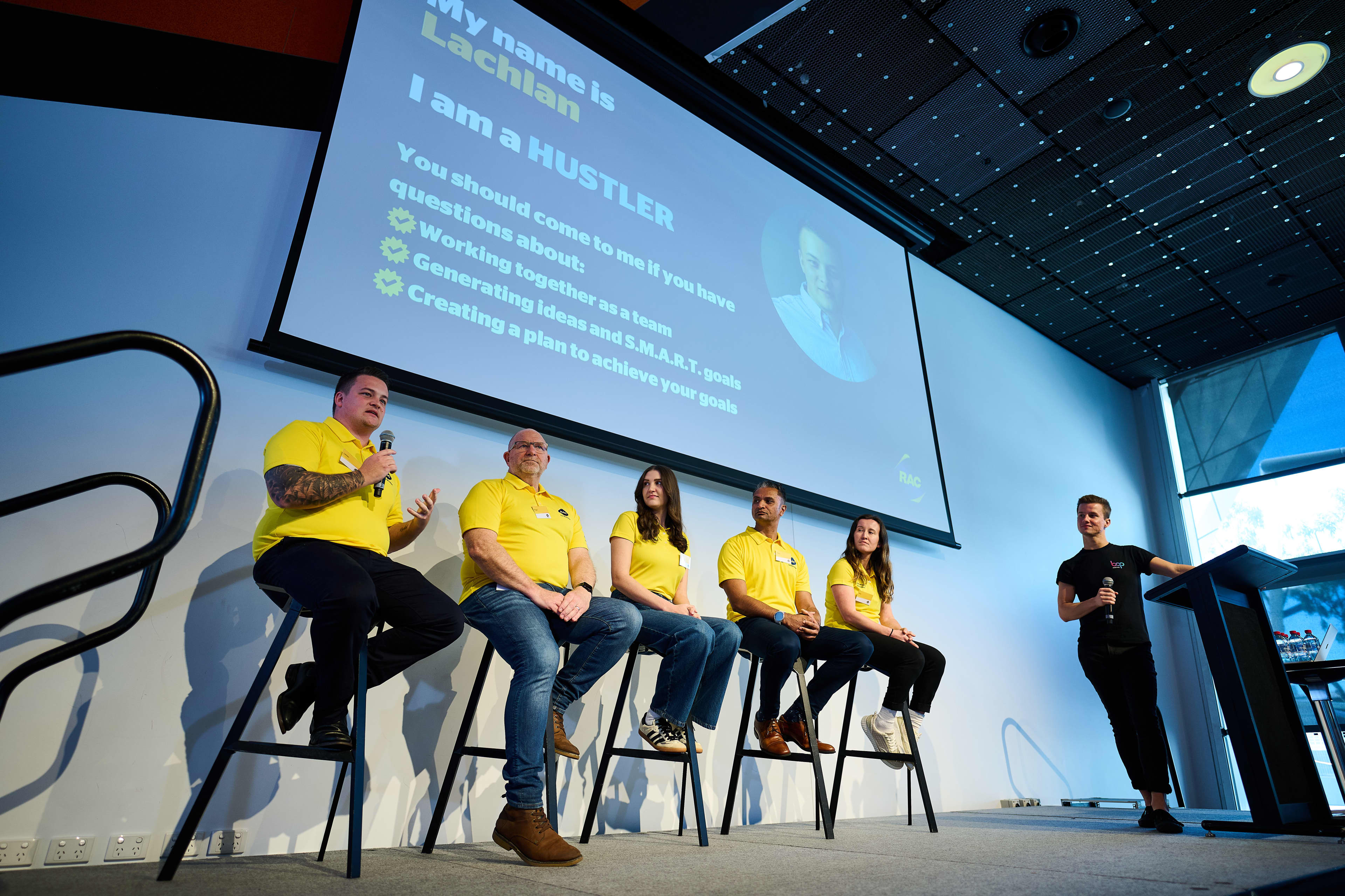 The five hackathon mentors sat on chairs on stage.