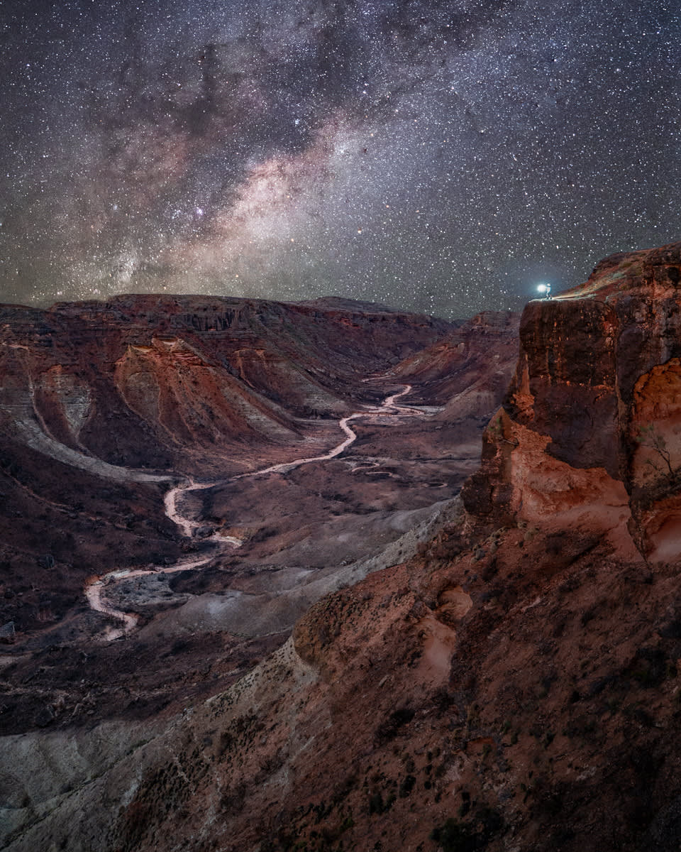 A long exposure photograph showing the Milky Way over Charles Knife Canyon.
