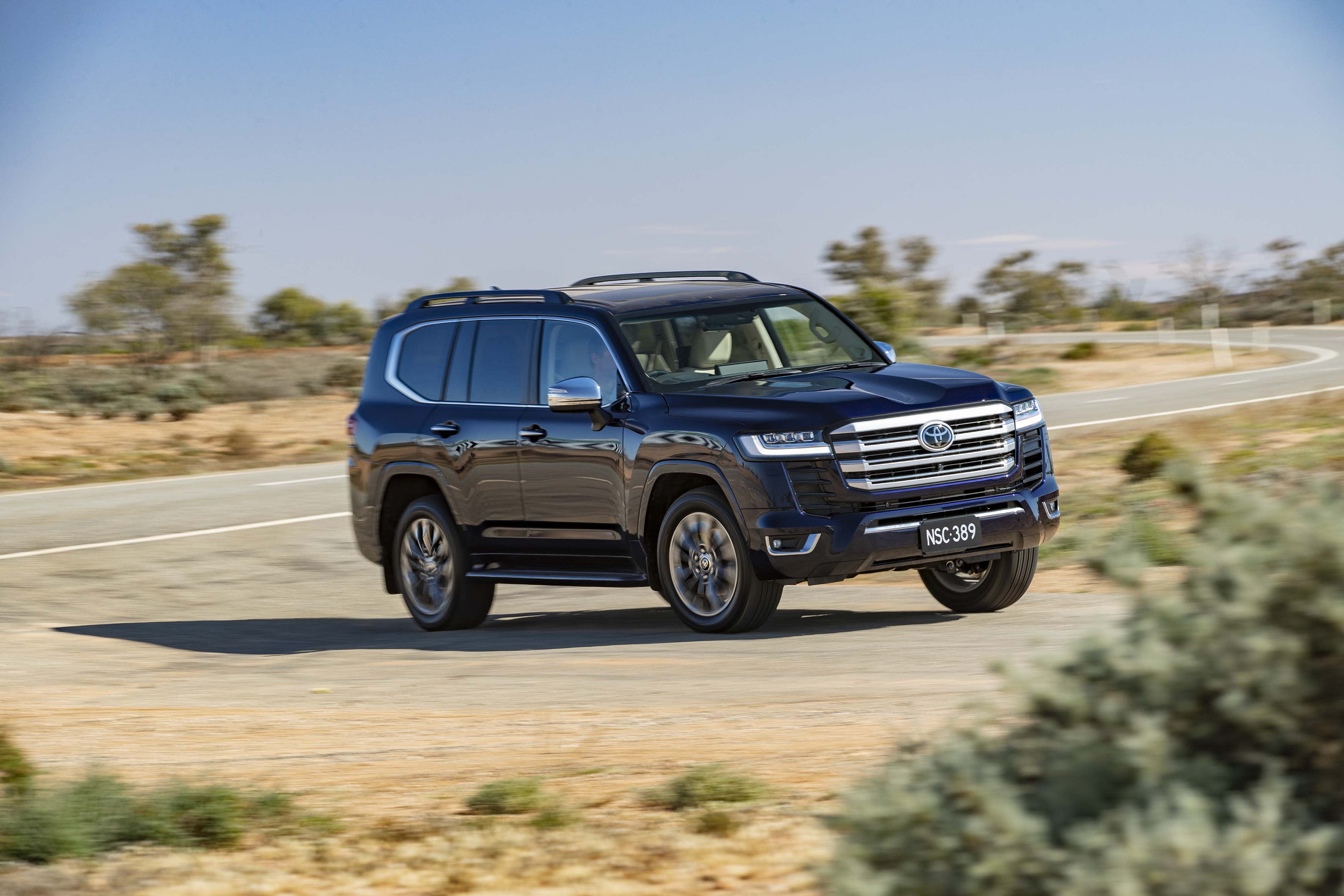 A black Toyota Landcruiser on a country road