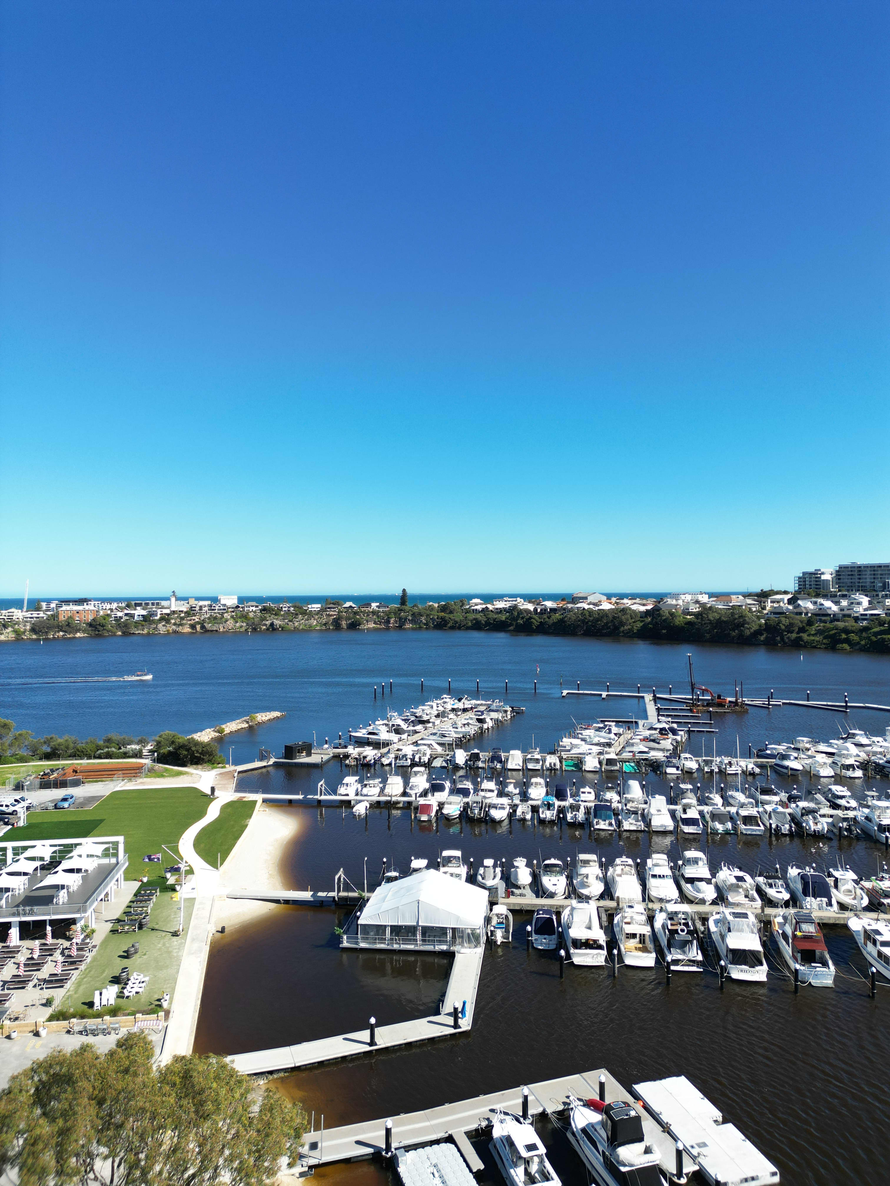 Swan Yacht Club and dozens of moored boats on Swan River