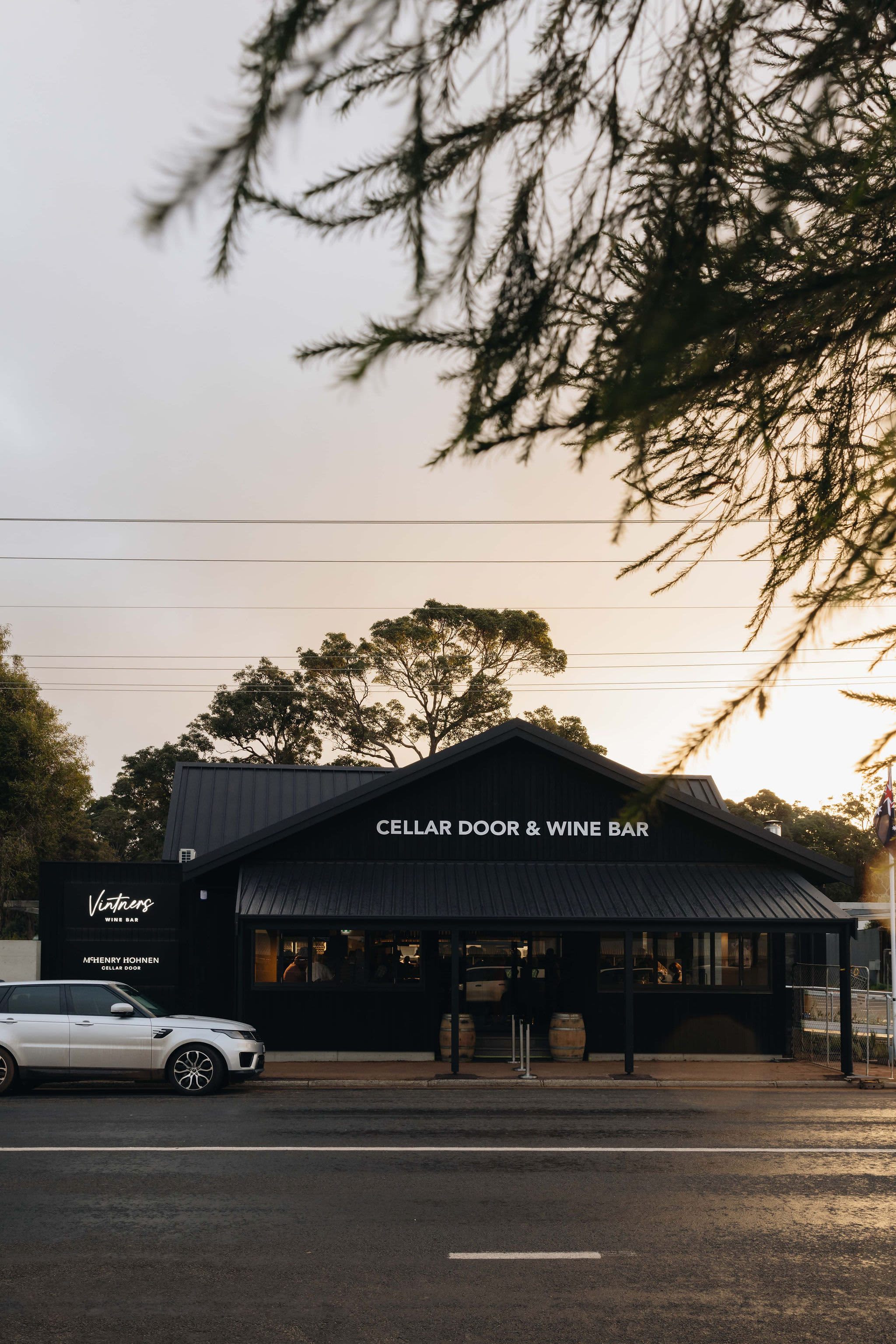 A car parked in front of the new Vintners wine bar and cellar door at sunset