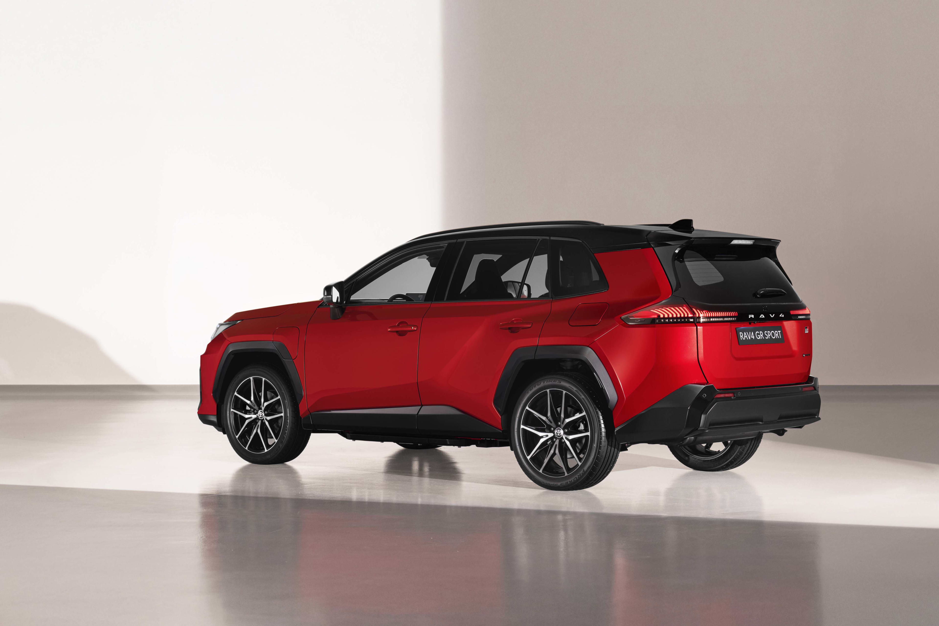 A red Toyota RAV 4 in a studio setting