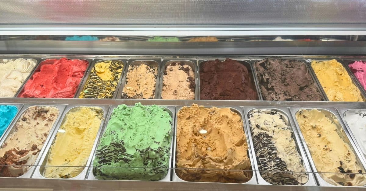 Gelato cabinet full of colourful icecream flavours
