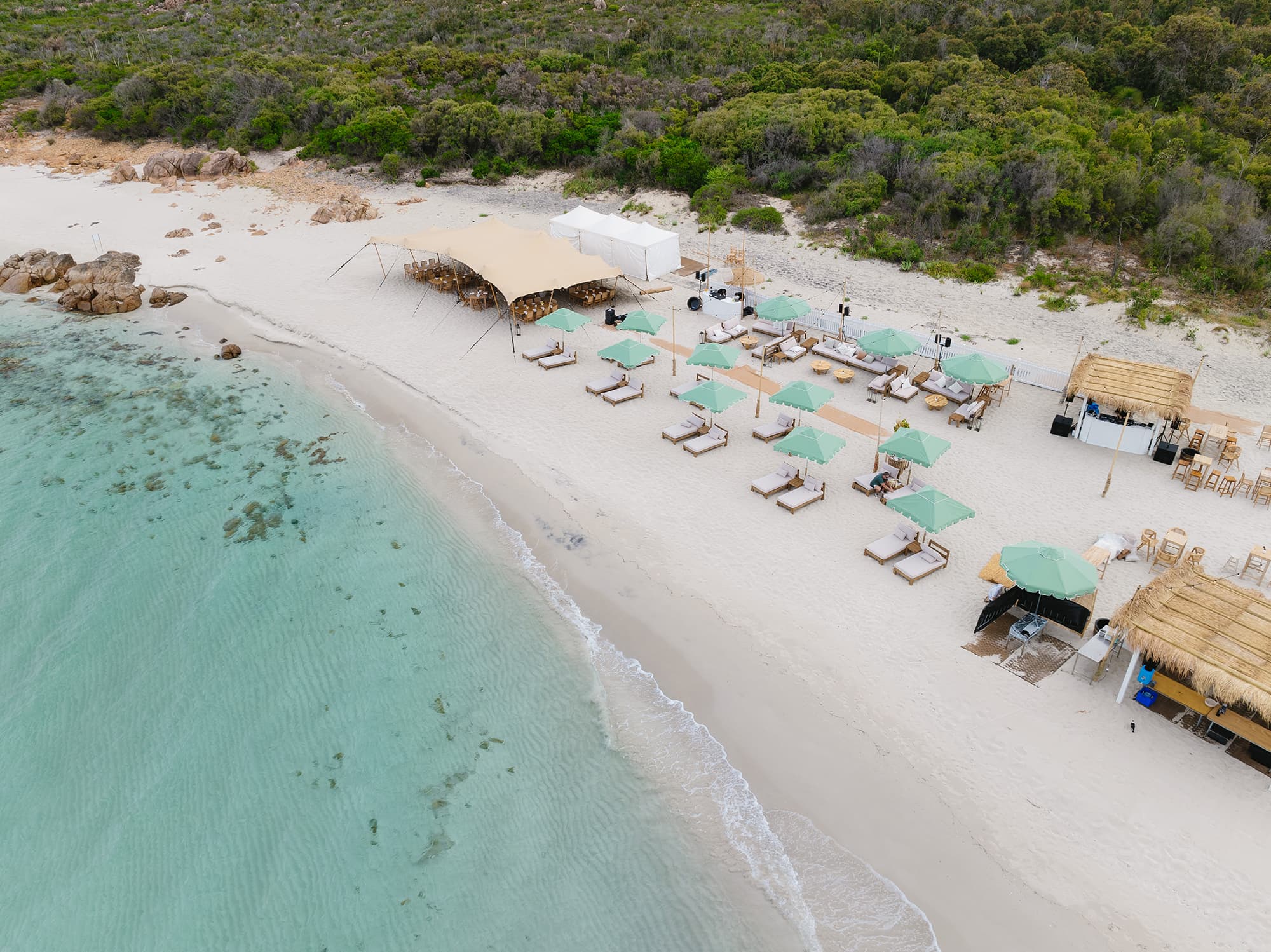 An aerial view of beach cabanas and beach shelters