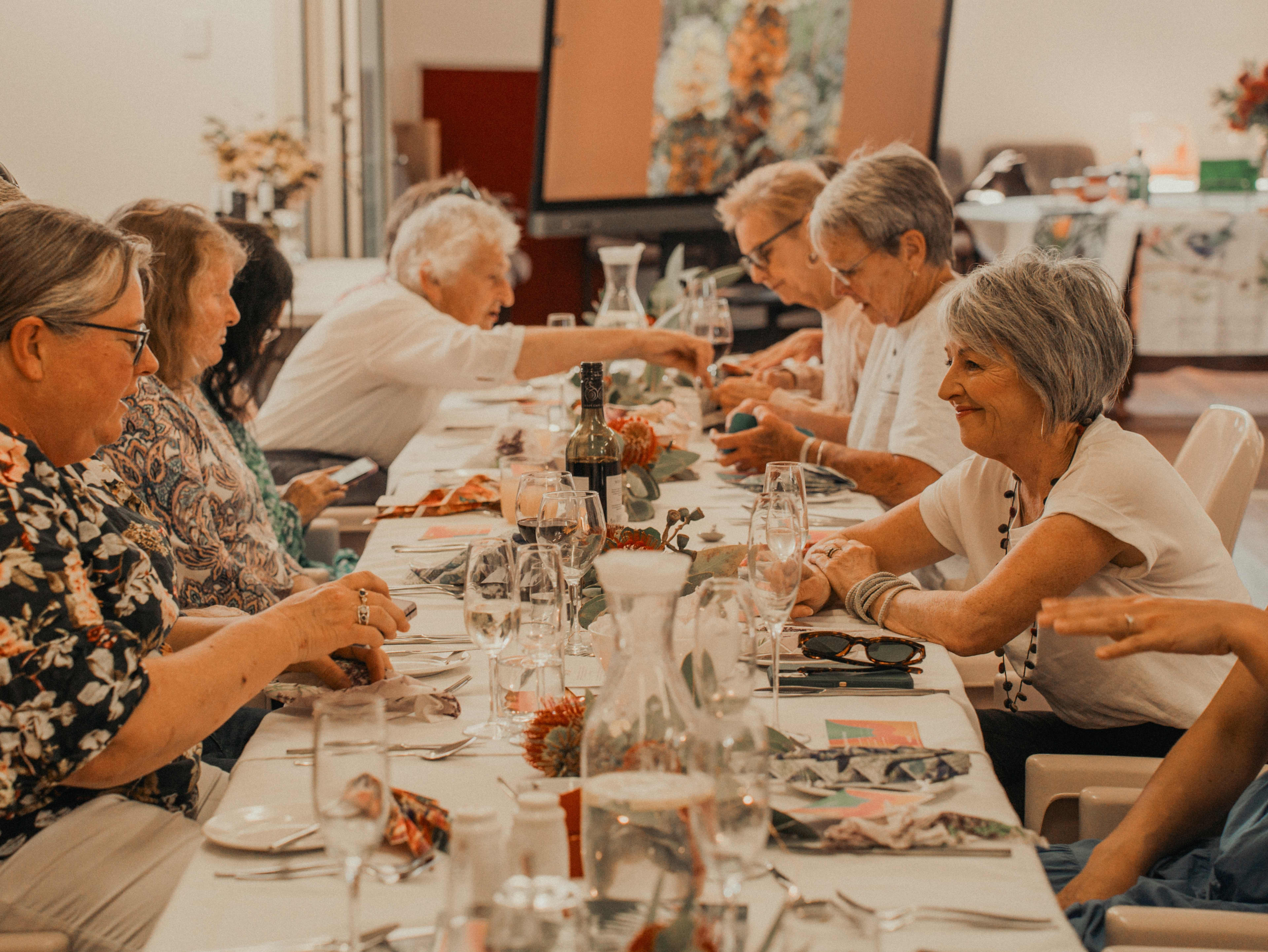 People sitting at a long dining table