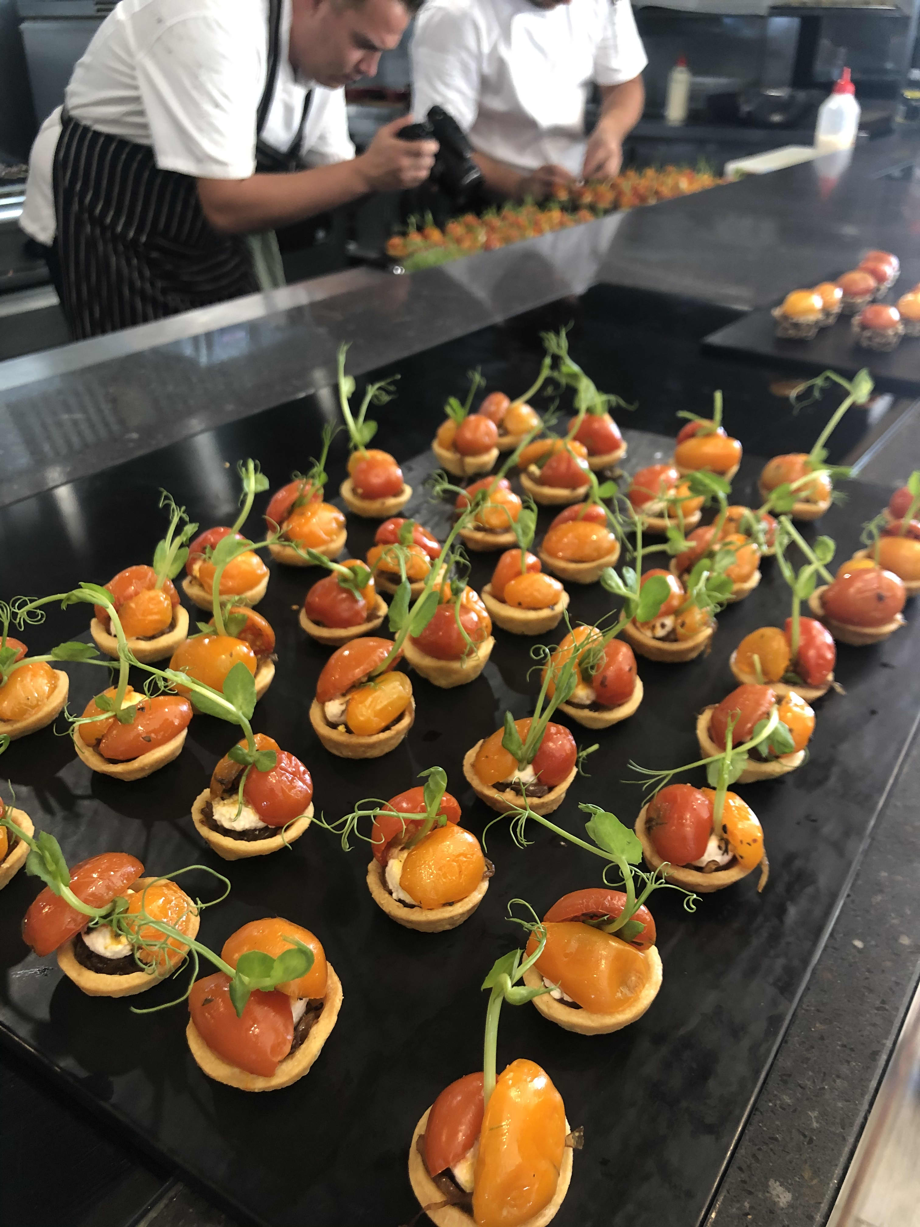 A row of colourful hors d'oeuvres in commercial kitchen