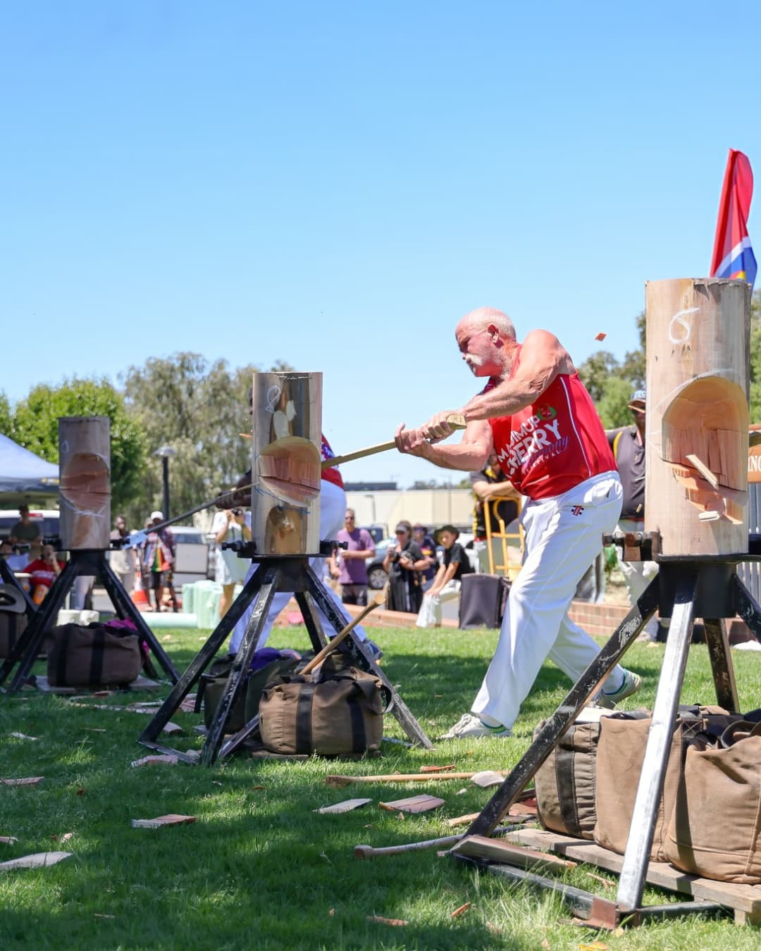 Men participating in log chopping competition