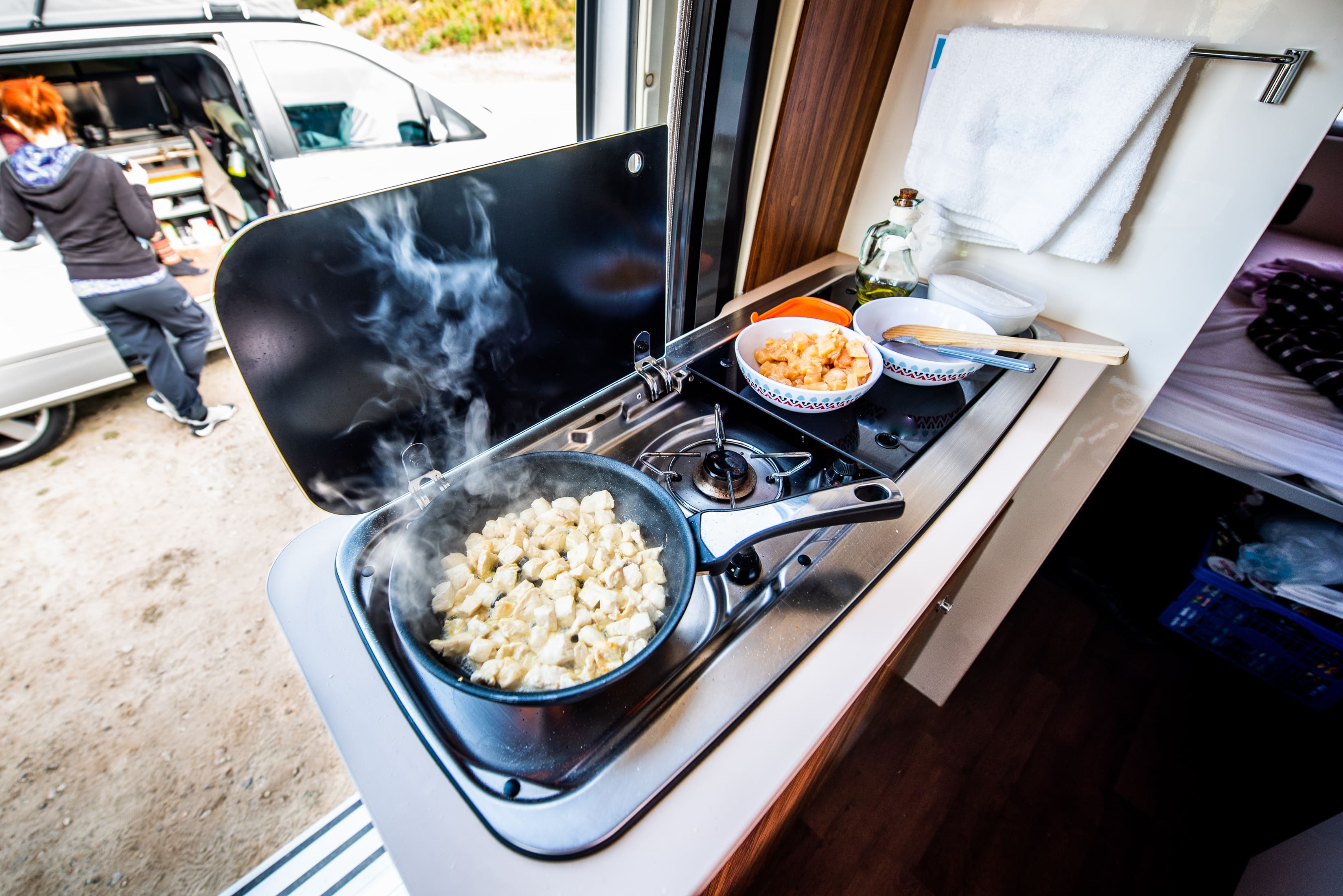 Food cooking on a stove in a caravan
