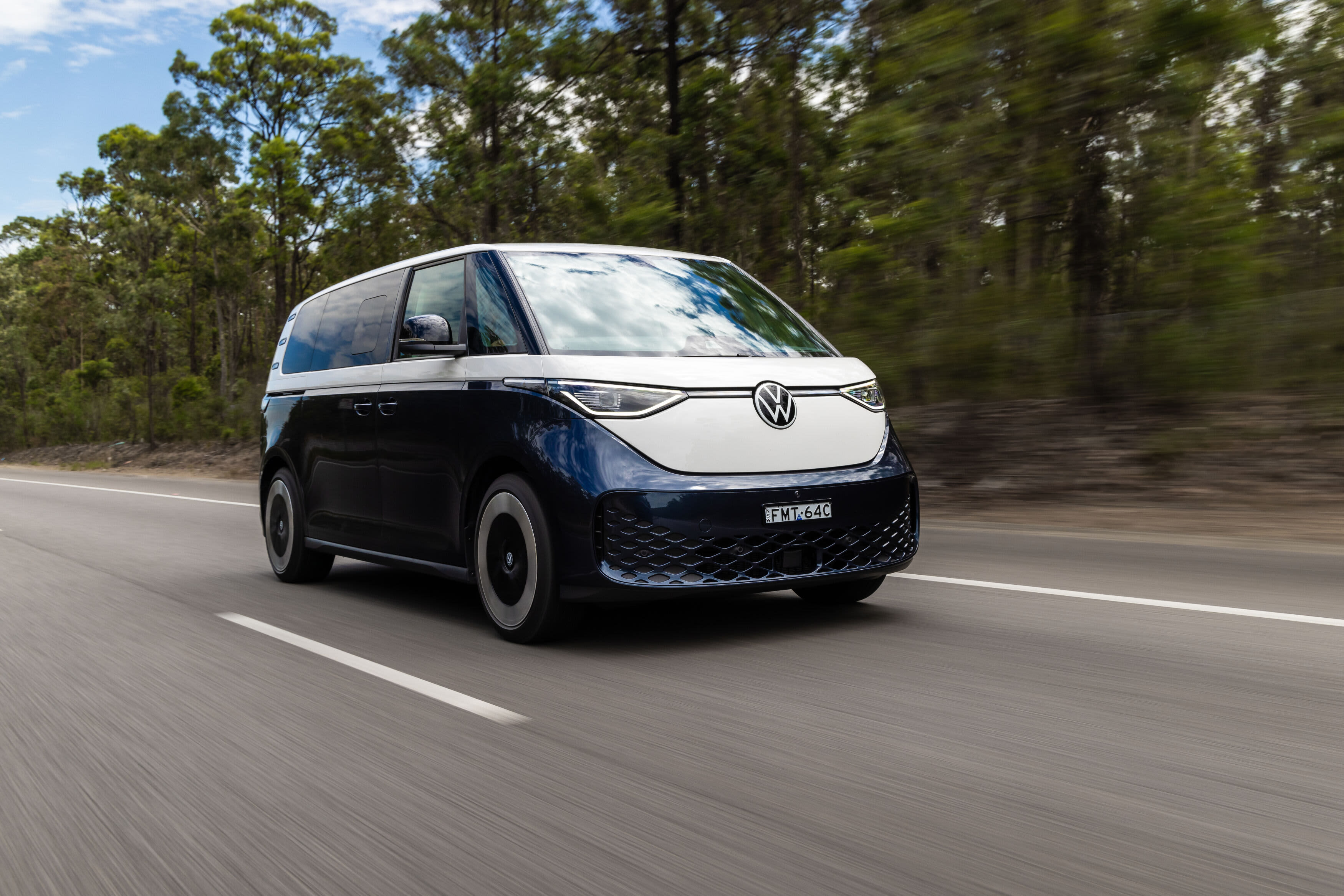 A VW ID Buzz driving on a country road