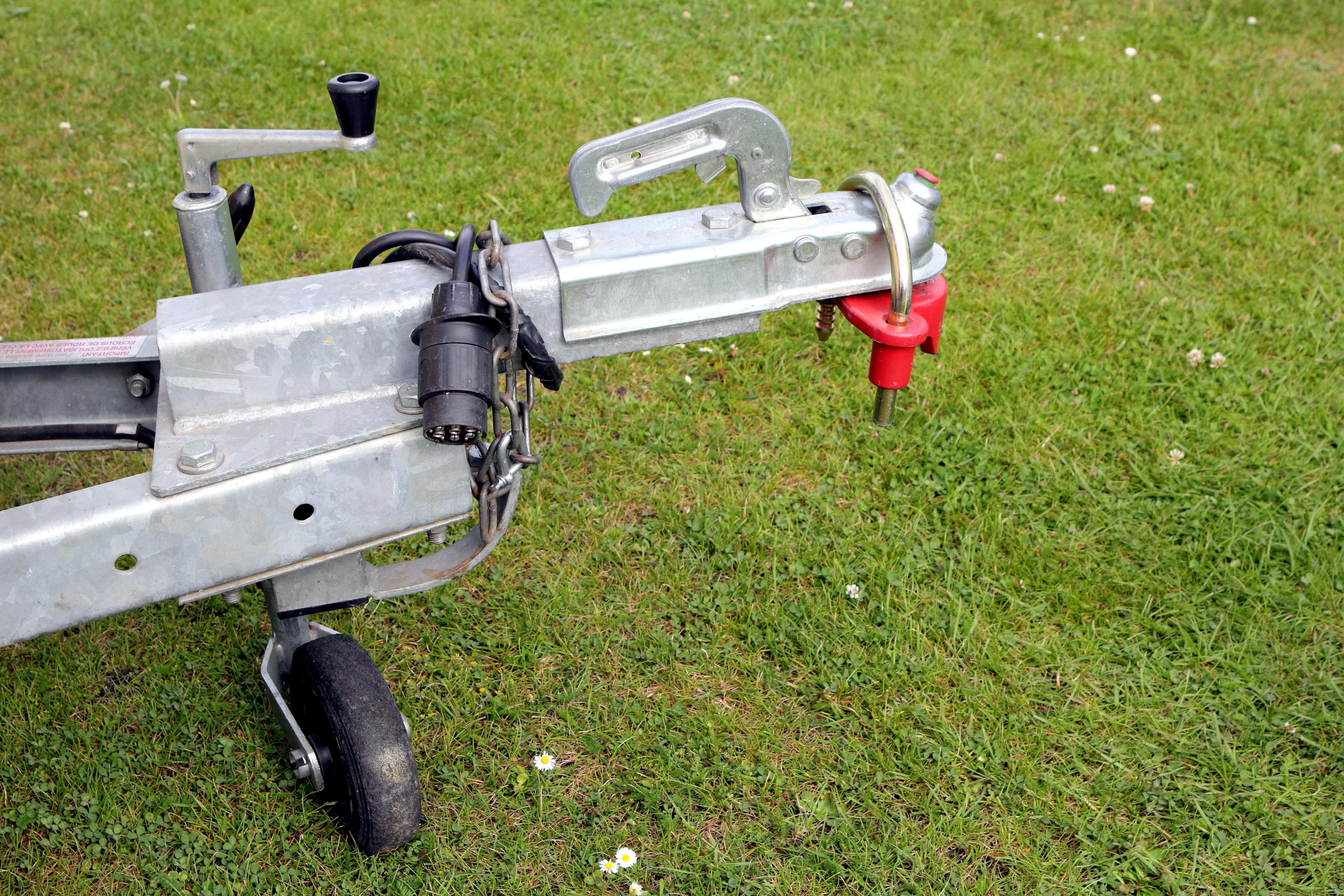 A close up of a caravan hitching and jockey wheel