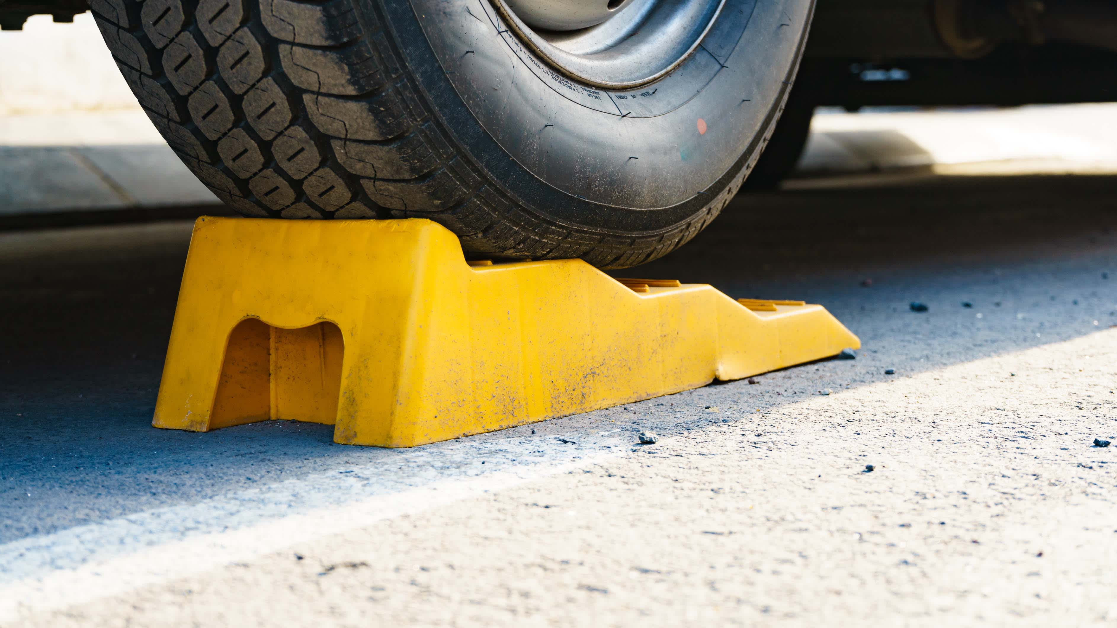 A caravan tyre raised on a wheel ramp