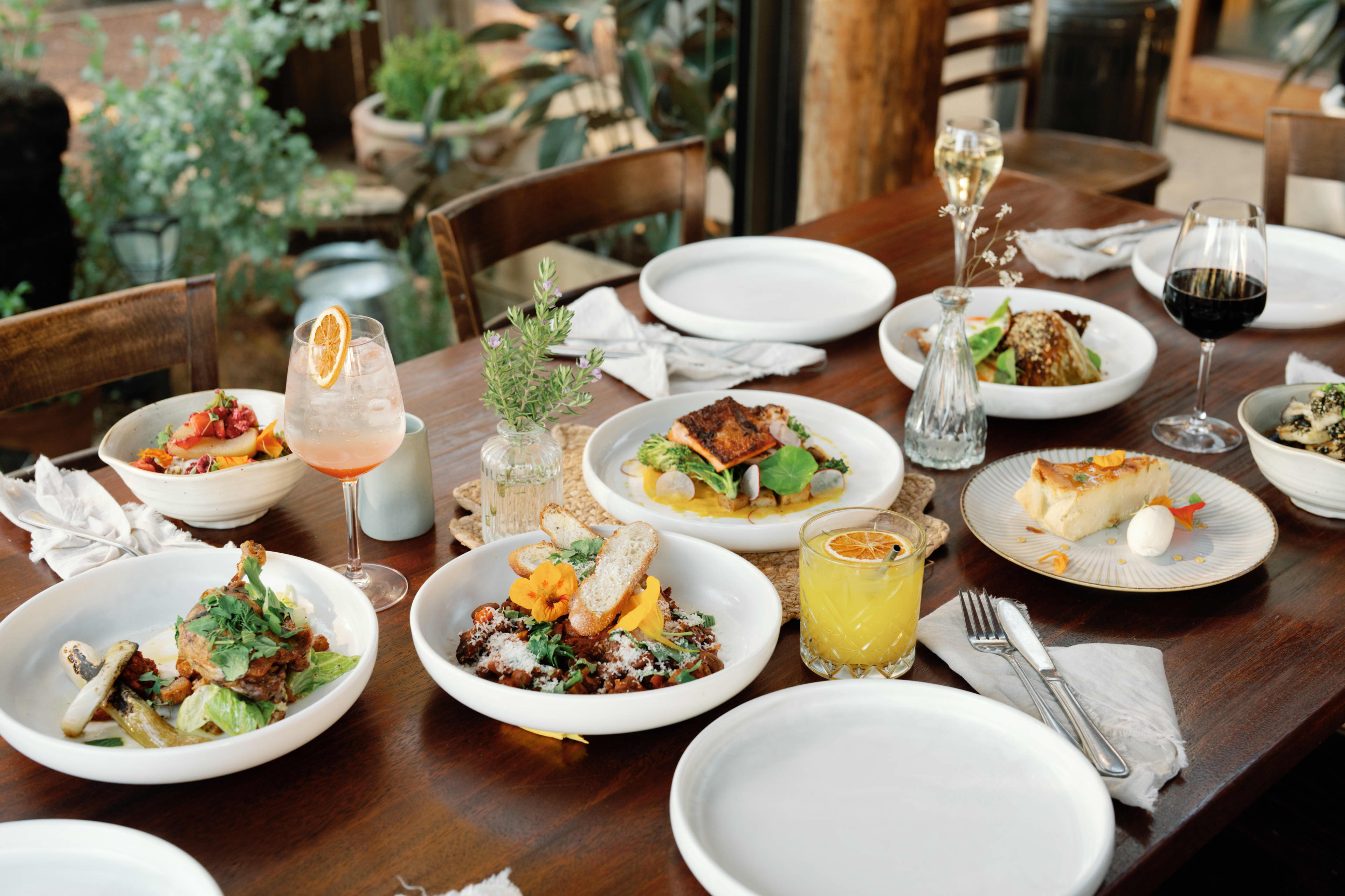 Plates of food and wine with lined on a long table