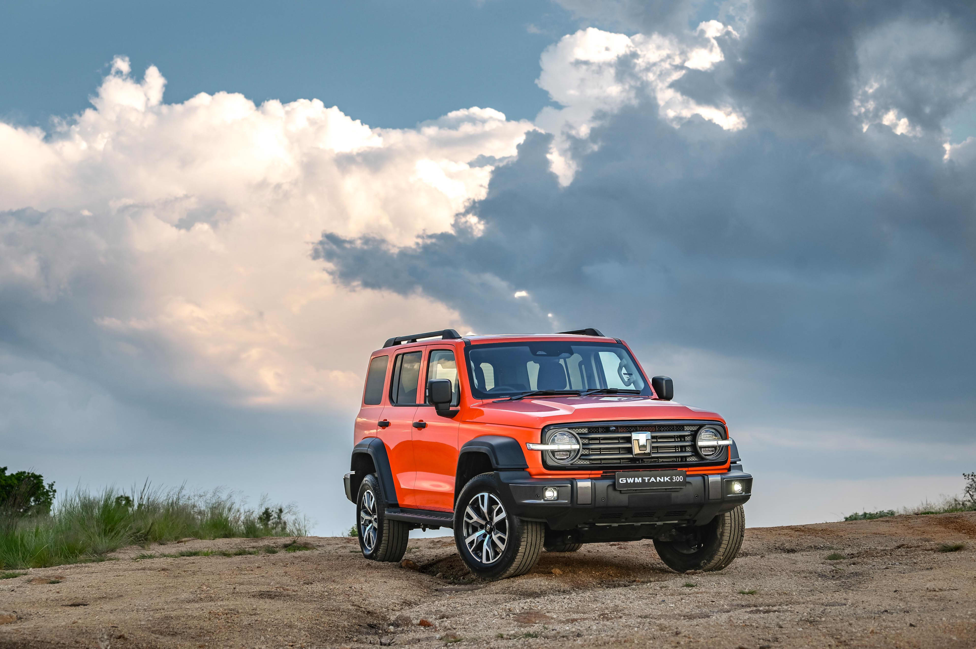 A red GWM Tank parked on a hillside