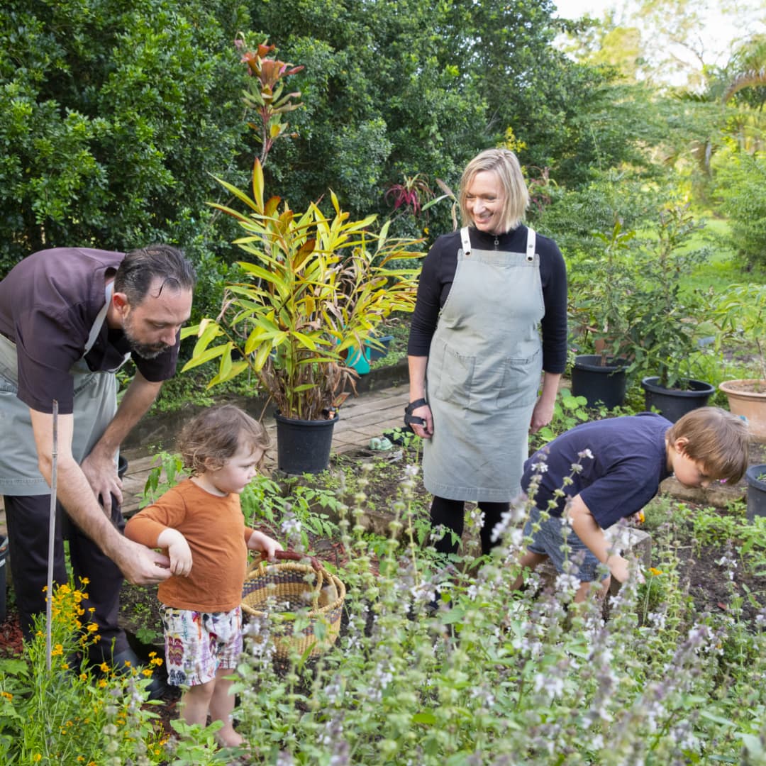 The Flack family in the garden picking herbs