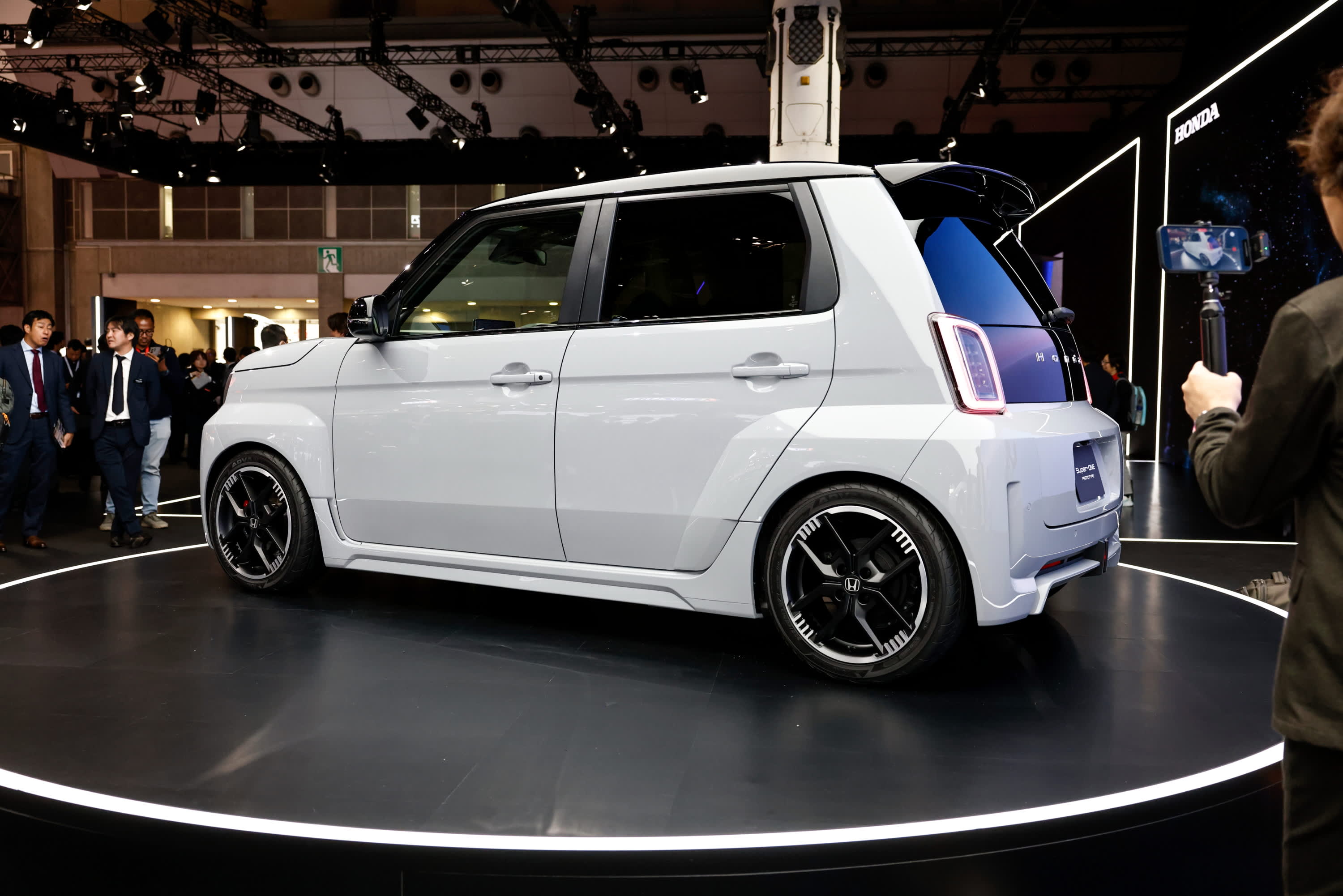 A white Honda Super ONE car on a display stand