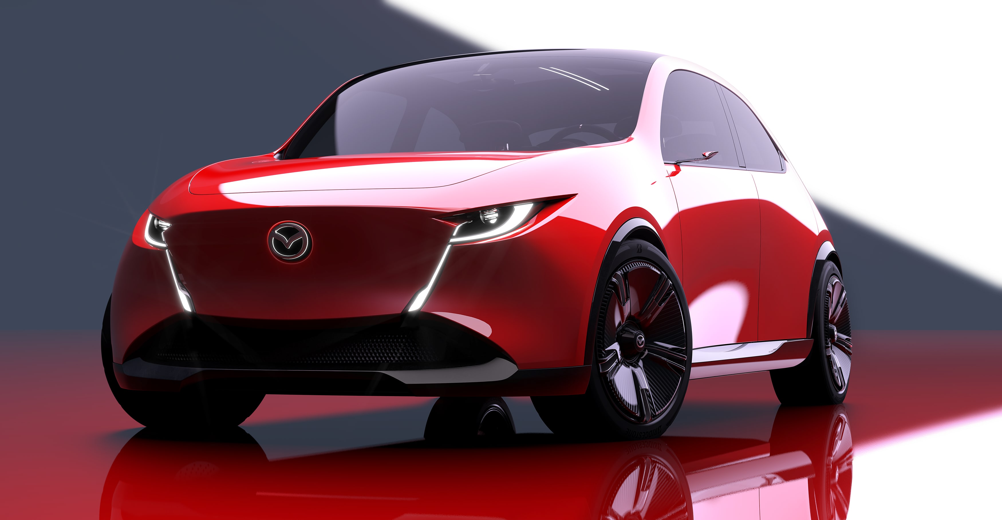 A red Mazda Vision concept car in a studio setting