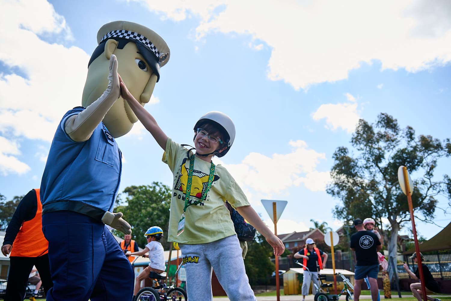 Child high fiving constable care mascot.
