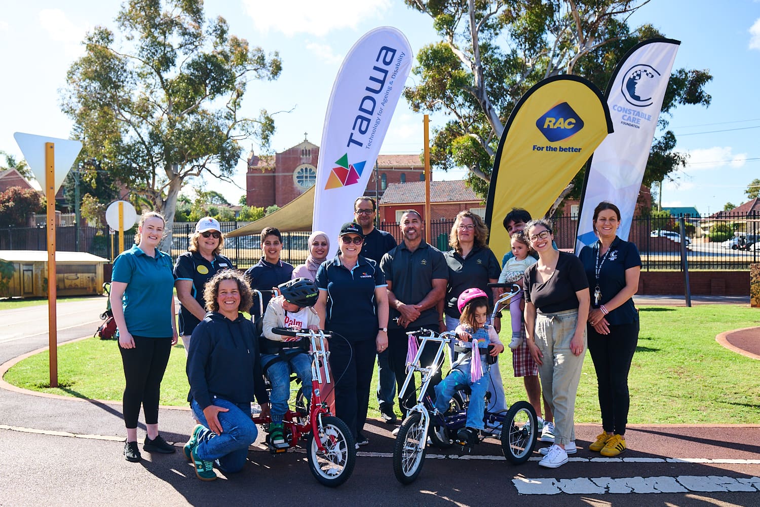 Group photo of two bikes being donated to two children.
