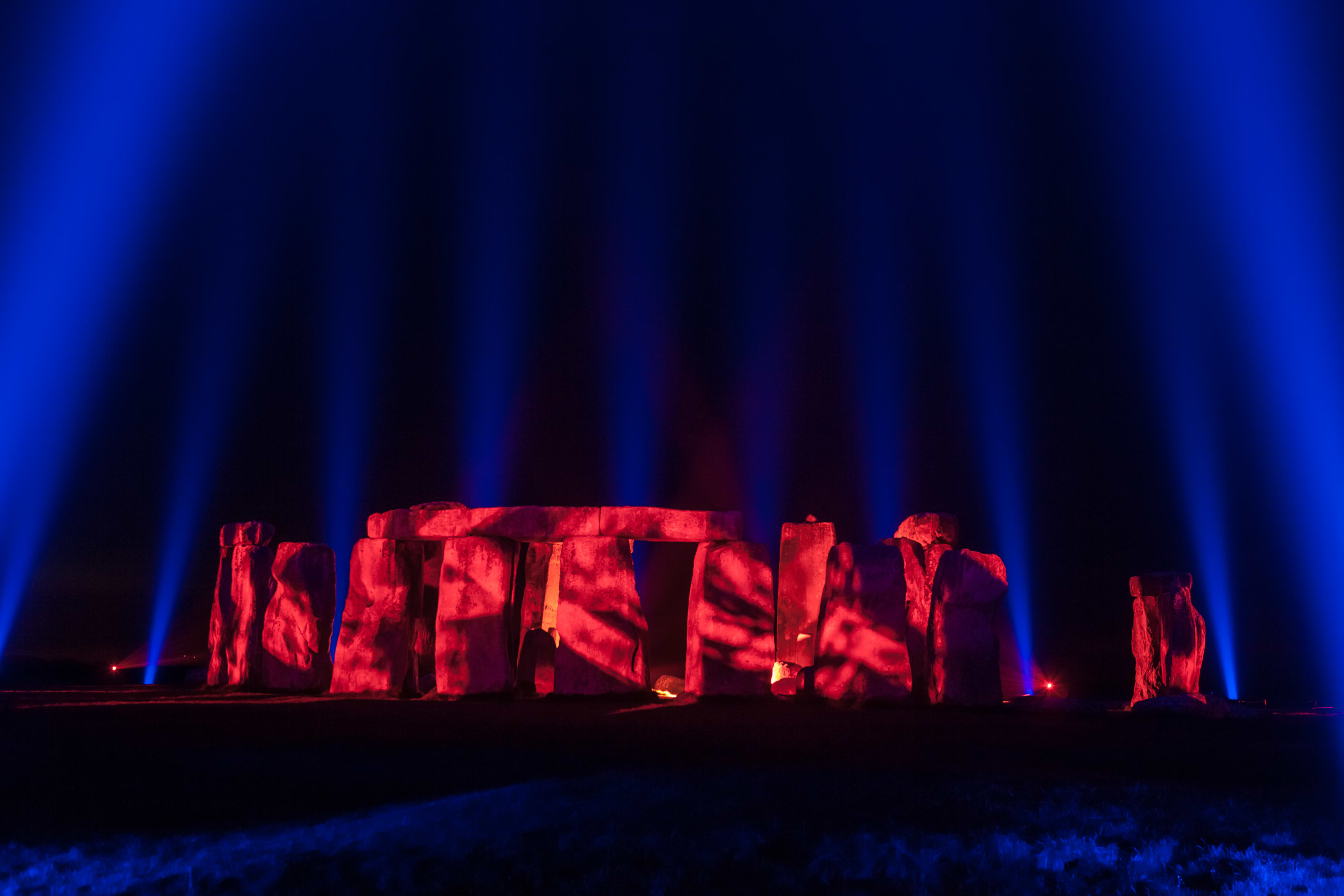 Stonehenge illuminated in red and blue