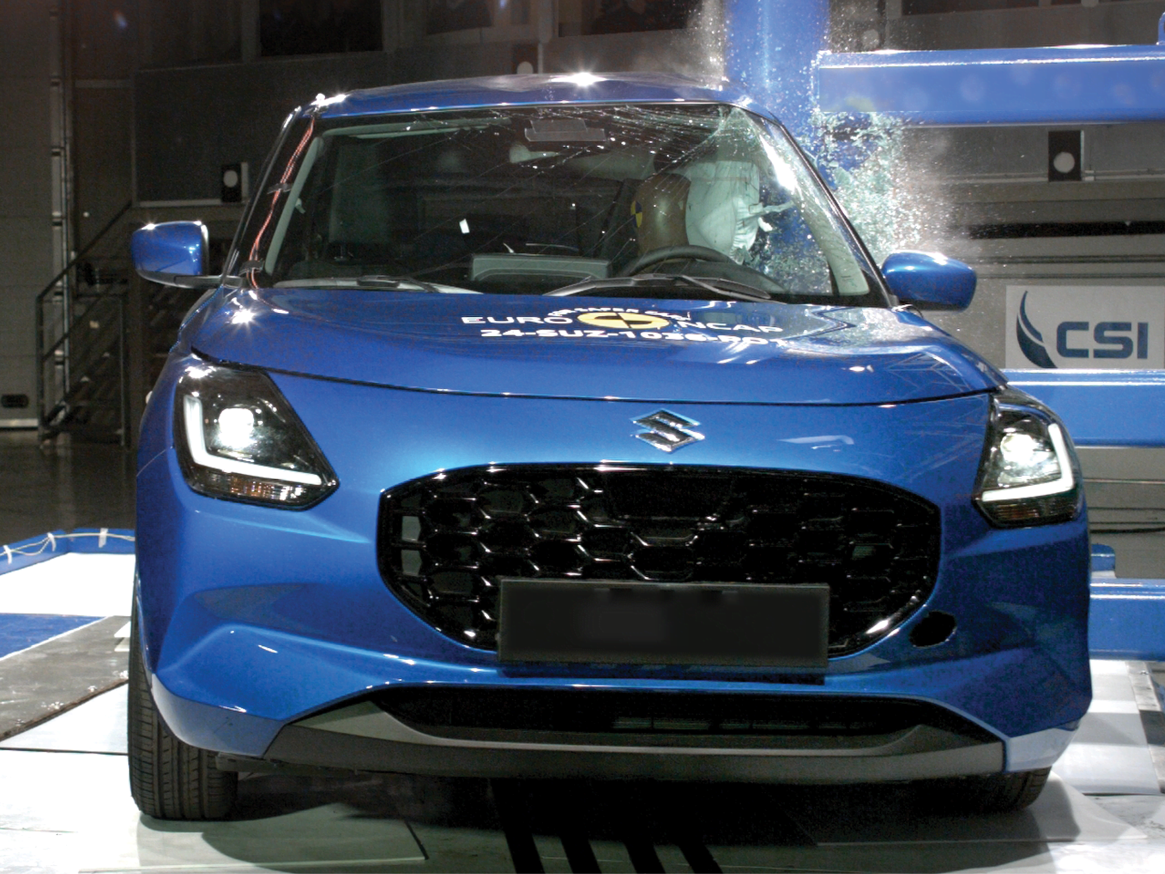 A blue Toyota Swift being crash tested