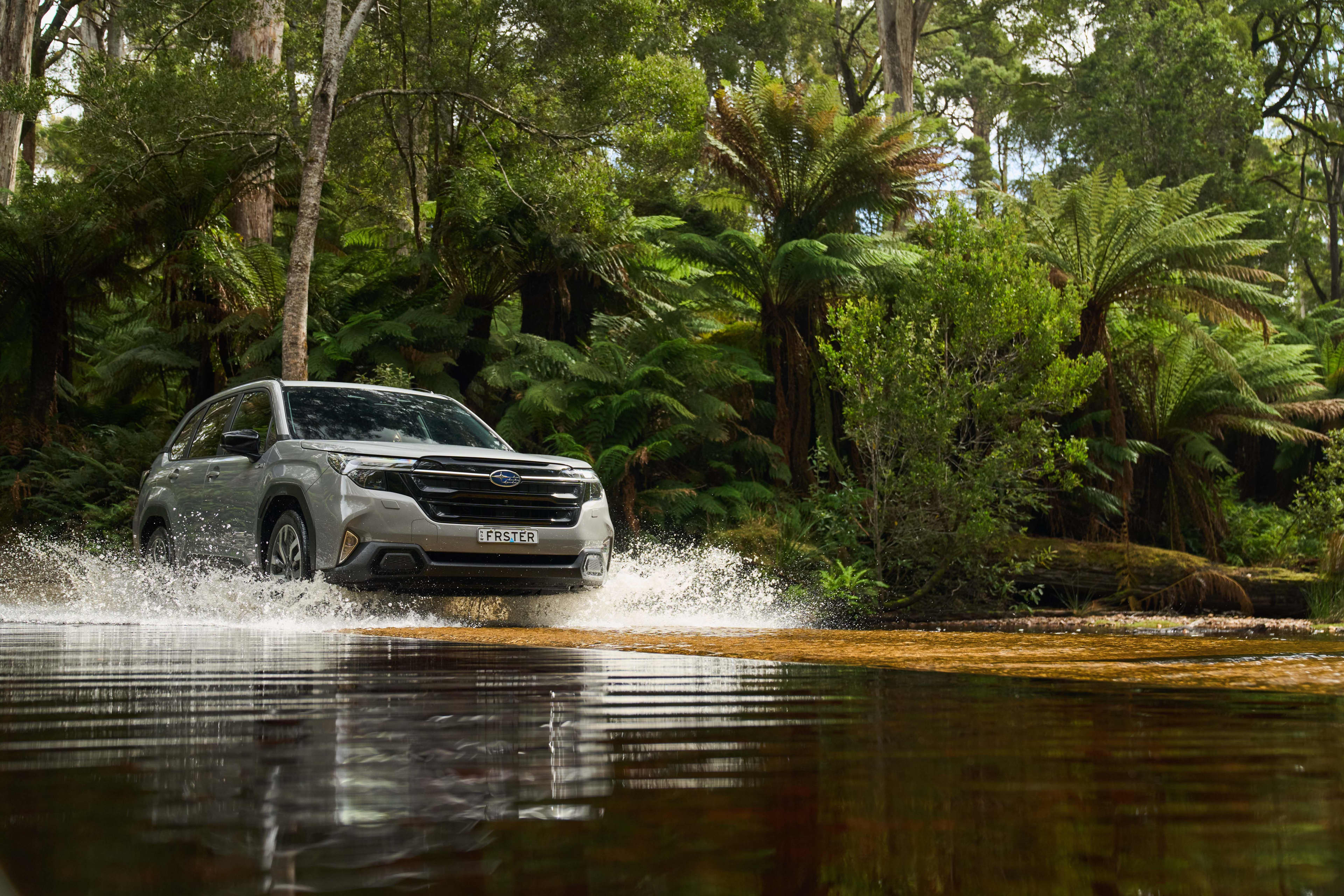 A Subaru Forester driving across a lake