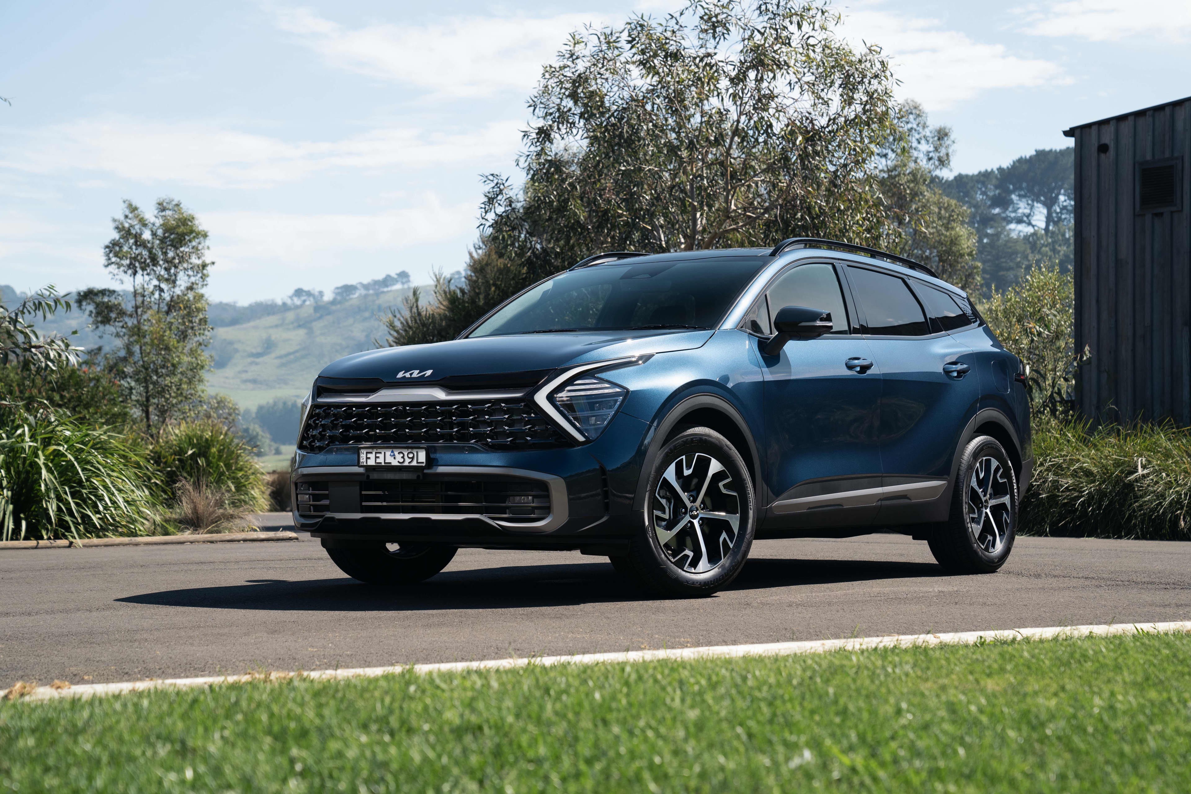 A Kia Sportage parked on a country road