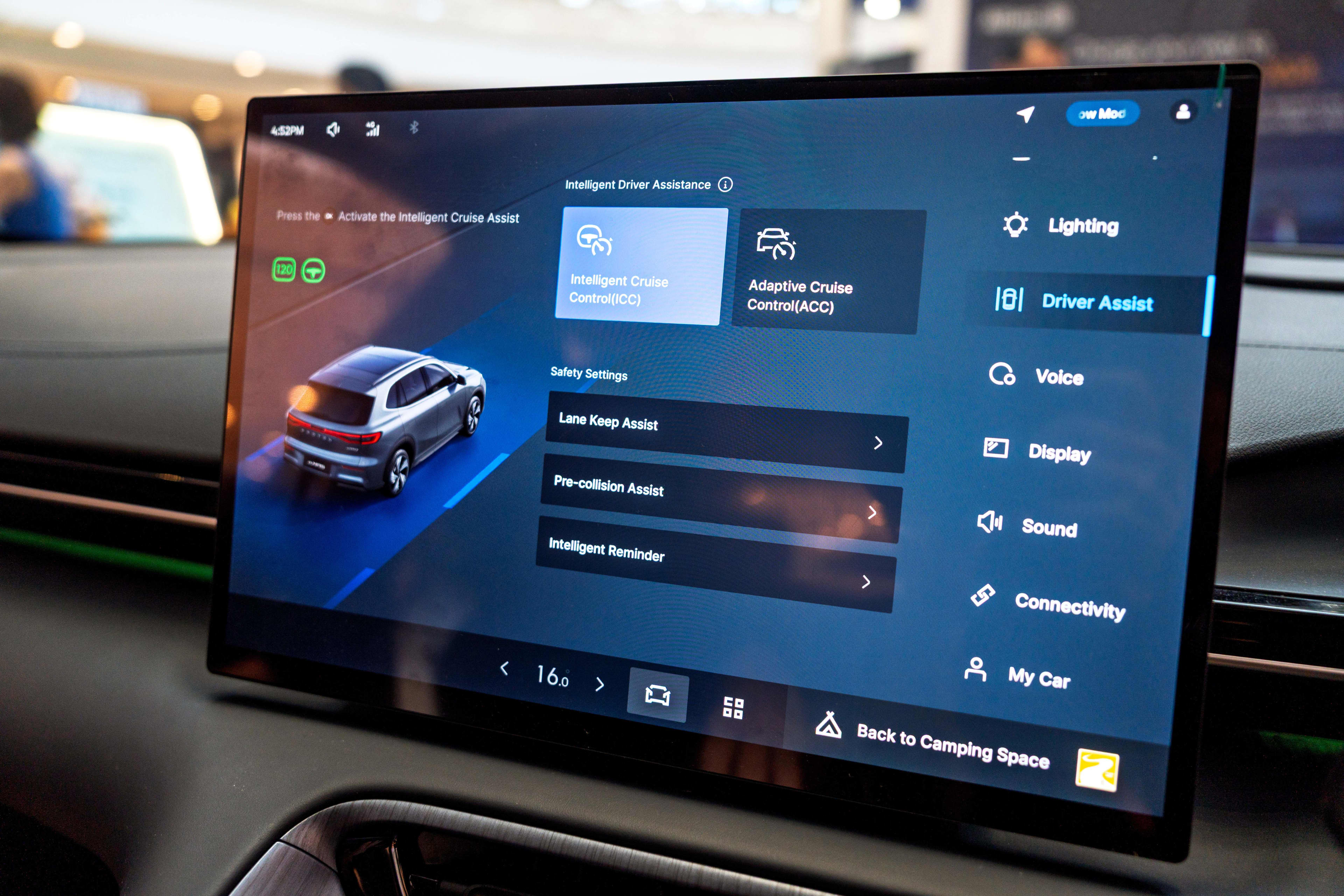 A display screen in a car showing driver assist features