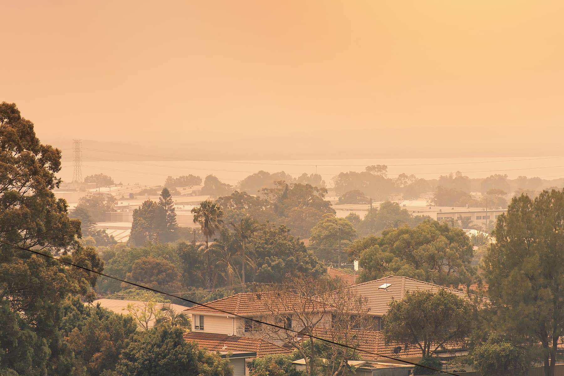A smoke-filled outlook over suburban homes