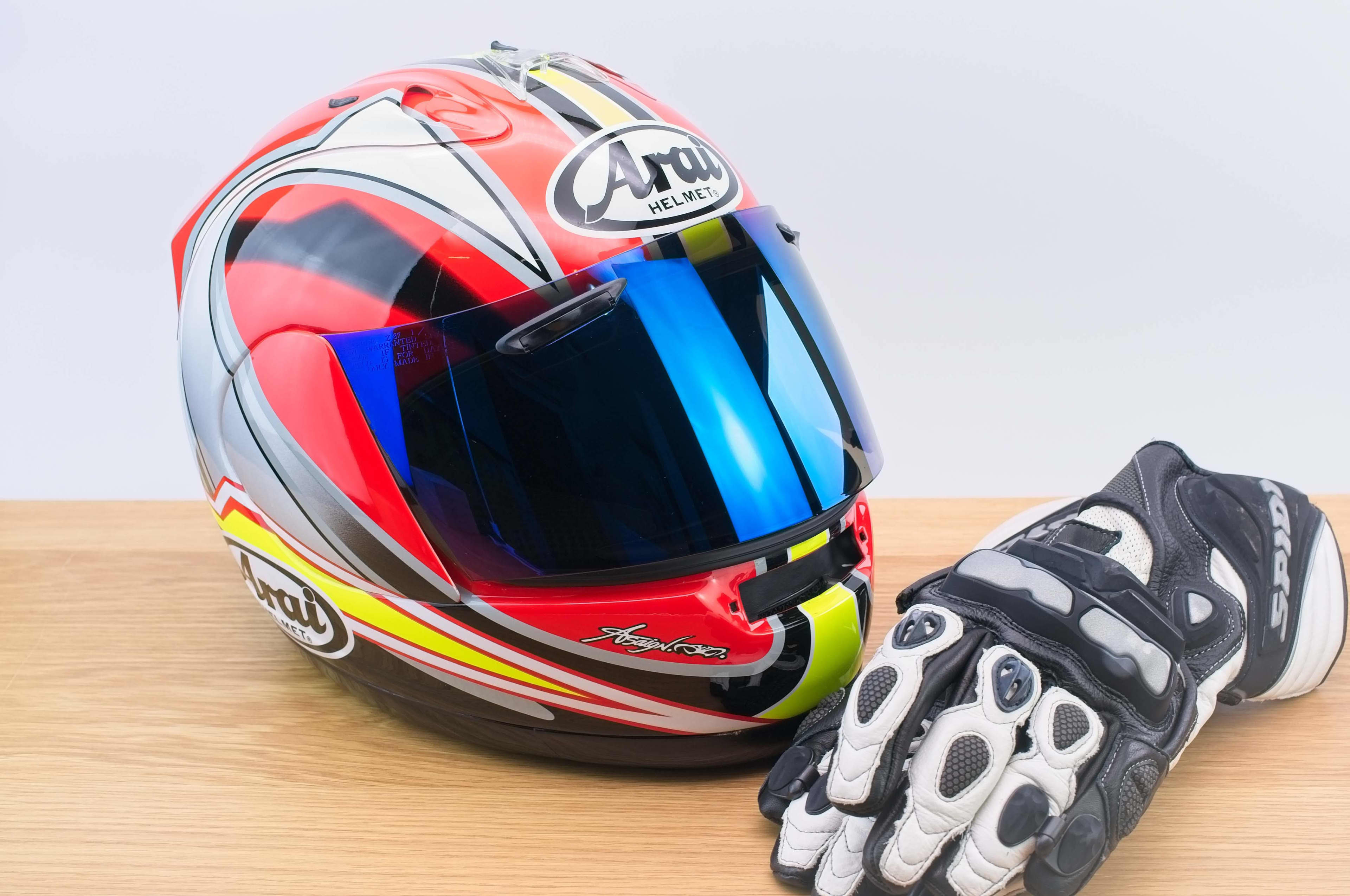 A close up of a motorcycle helmet and a glove