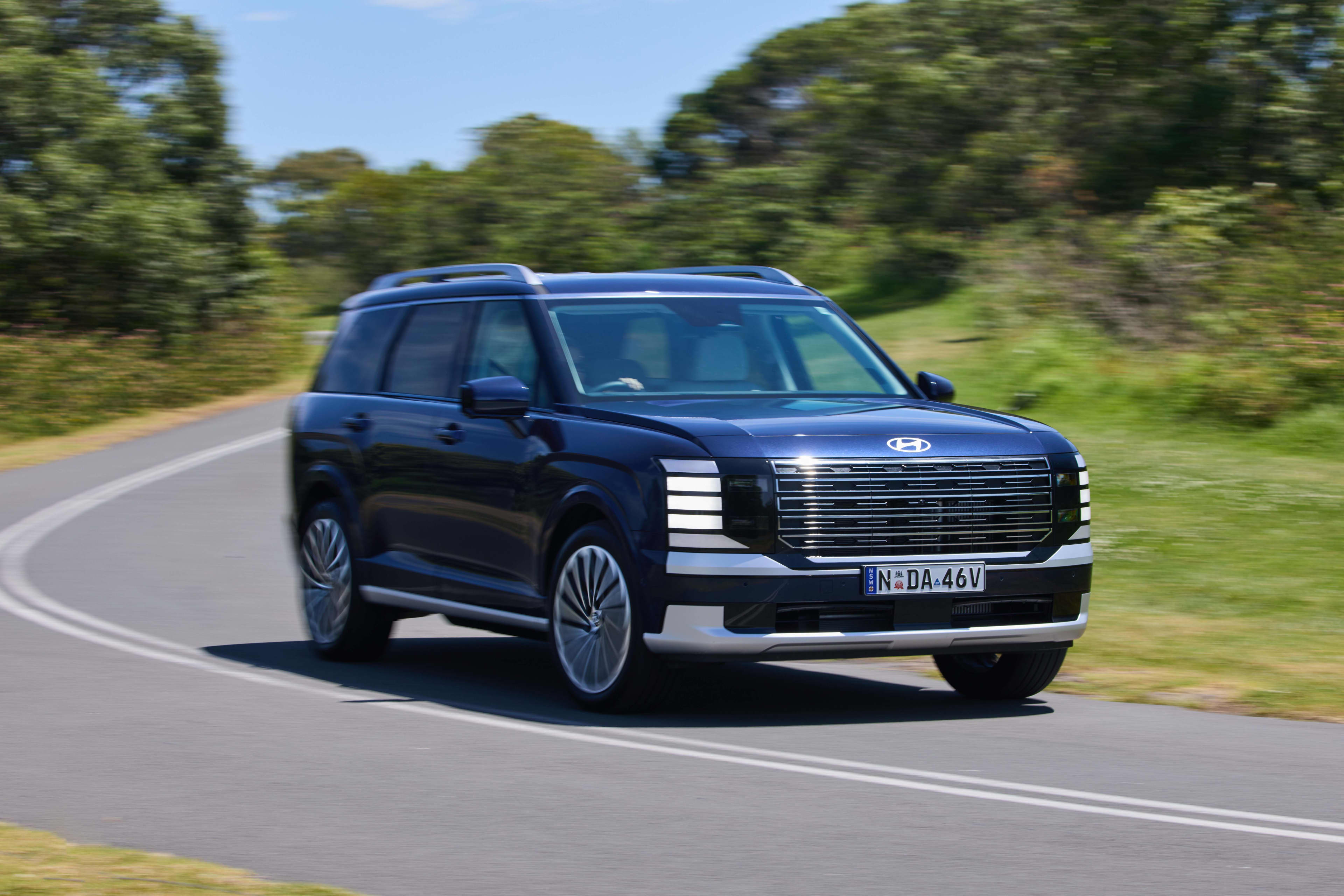 A black Hyundai_Palisade on a country road