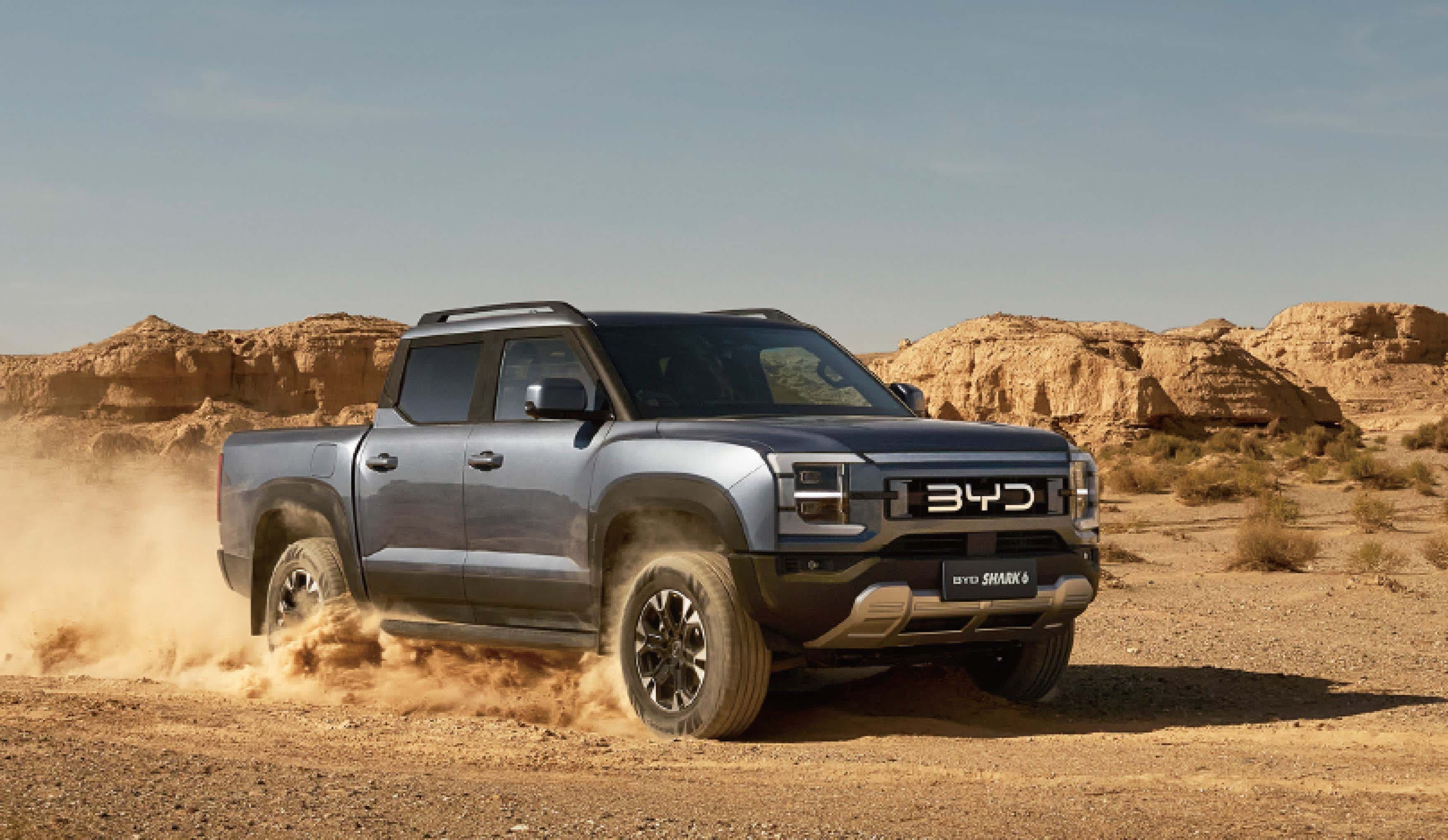 A blue BYD_Shark_6 in a desert landscape