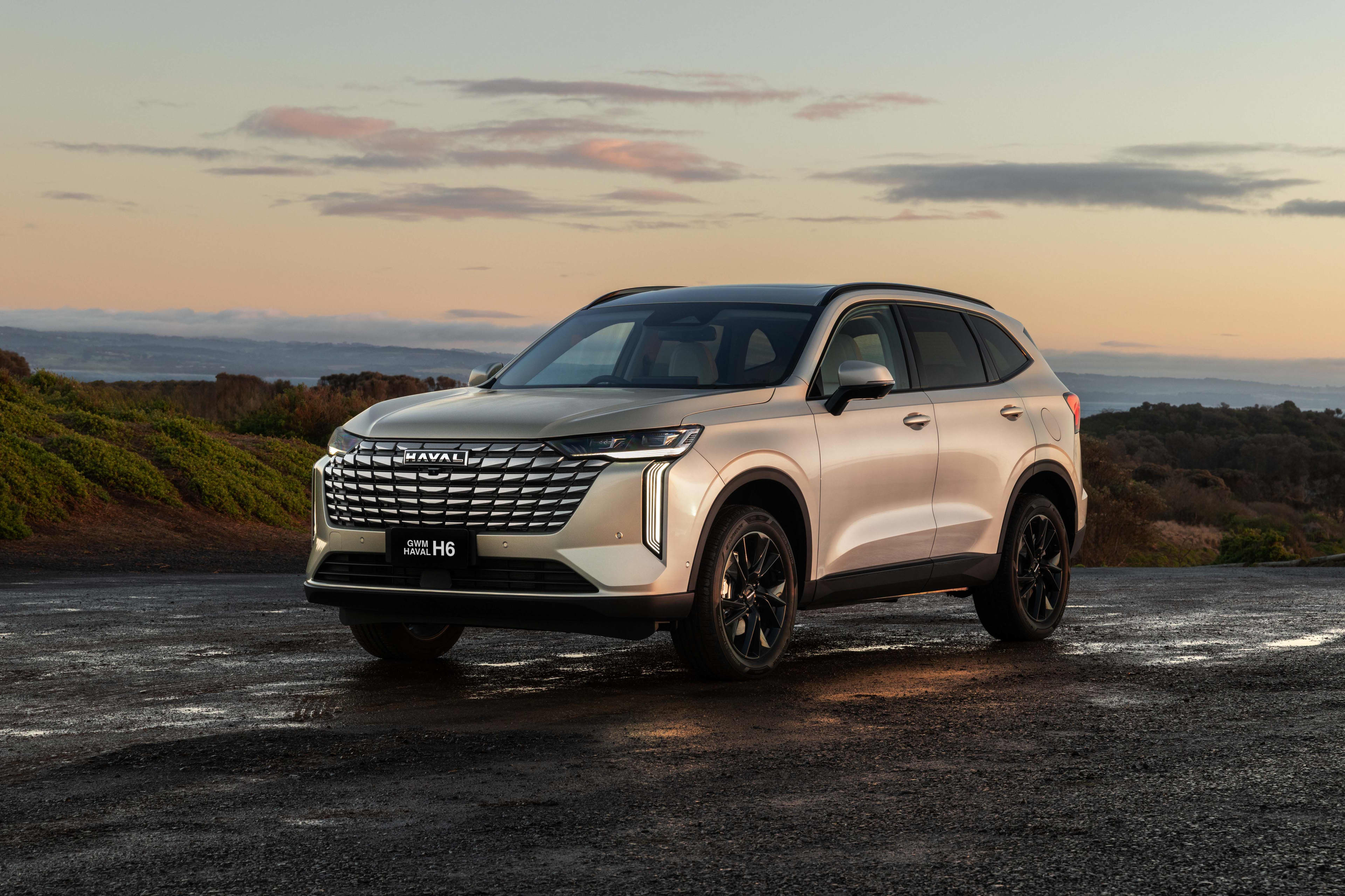 A white  Haval H6 parked in a mountainous region