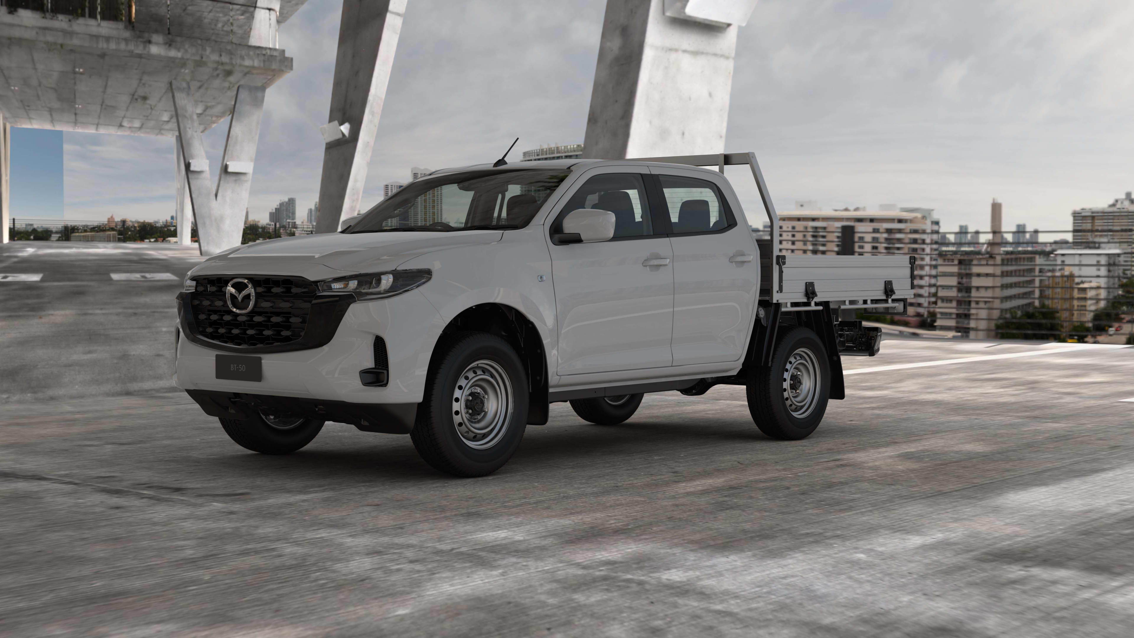 A white  Mazda_BT-50 Cab Chassis parked on a concrete slab