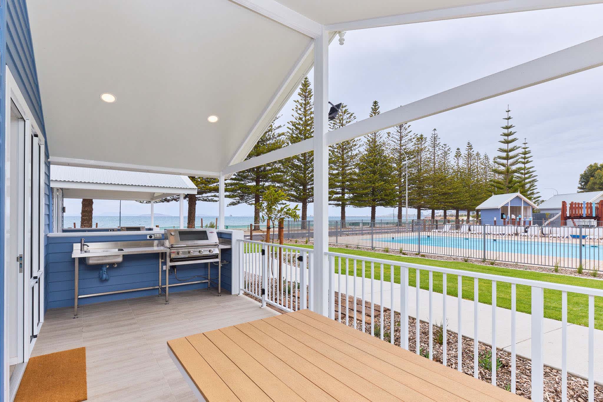 The front porch of a cabin overlooking the beach