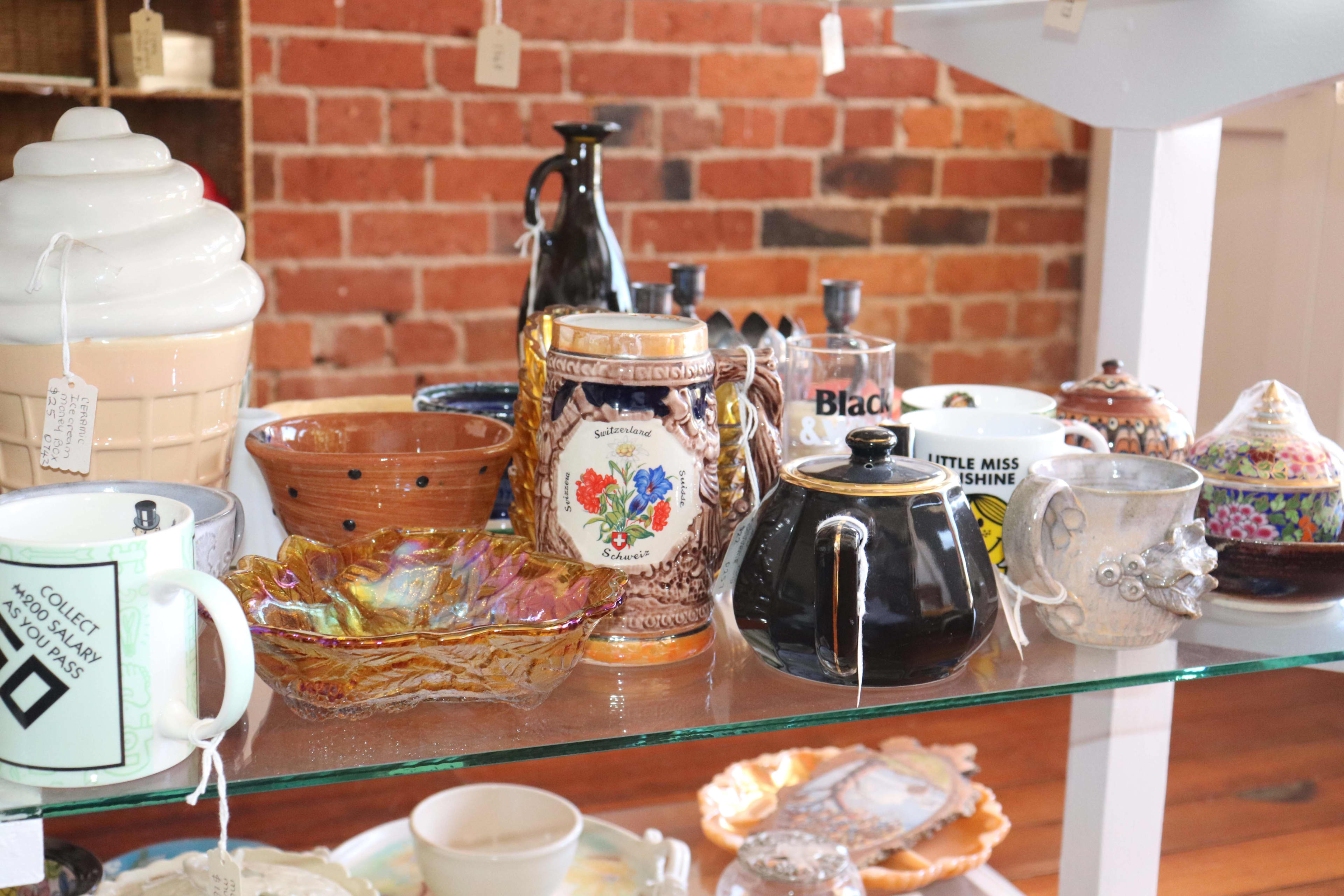 A table full of second-hand  homewares inside Bella Corella