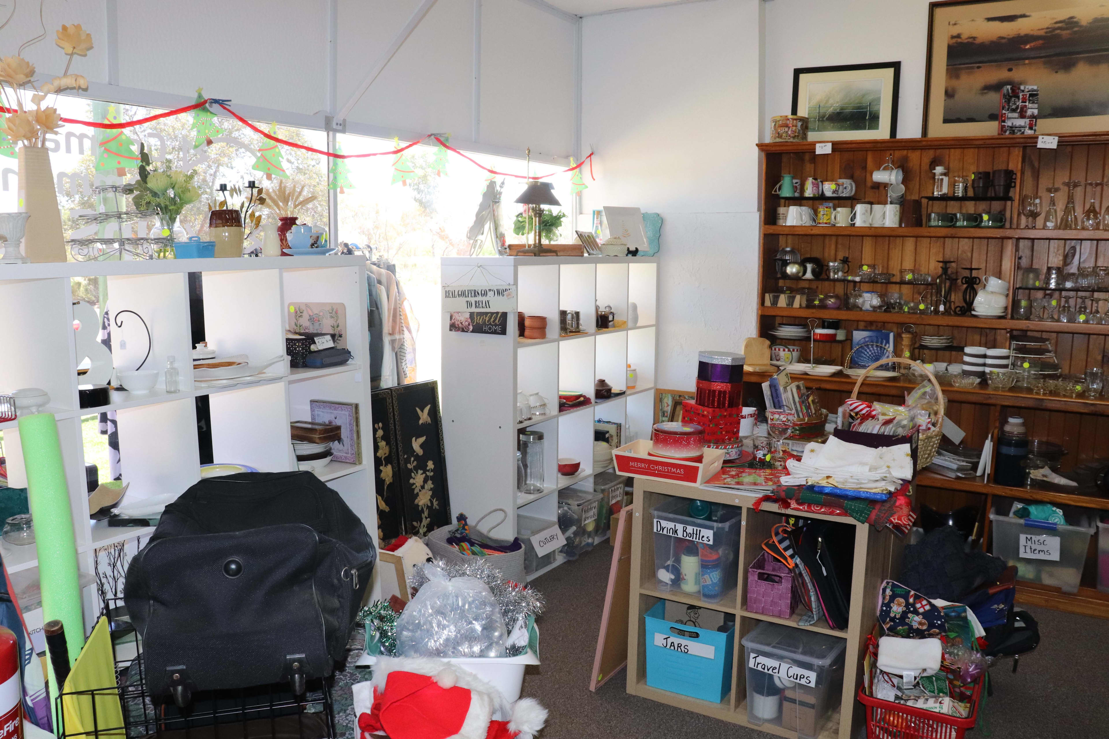 Shelves packed with second-hand goods inside a Goomalling op shop